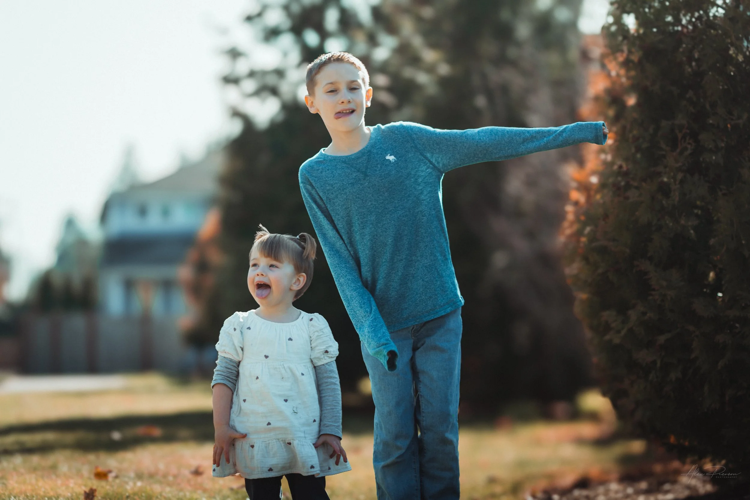   Little girl playfully making silly faces with her cousin during a candid family photo session Tumwater, WA – Pacific Northwest lifestyle family and children's photography.