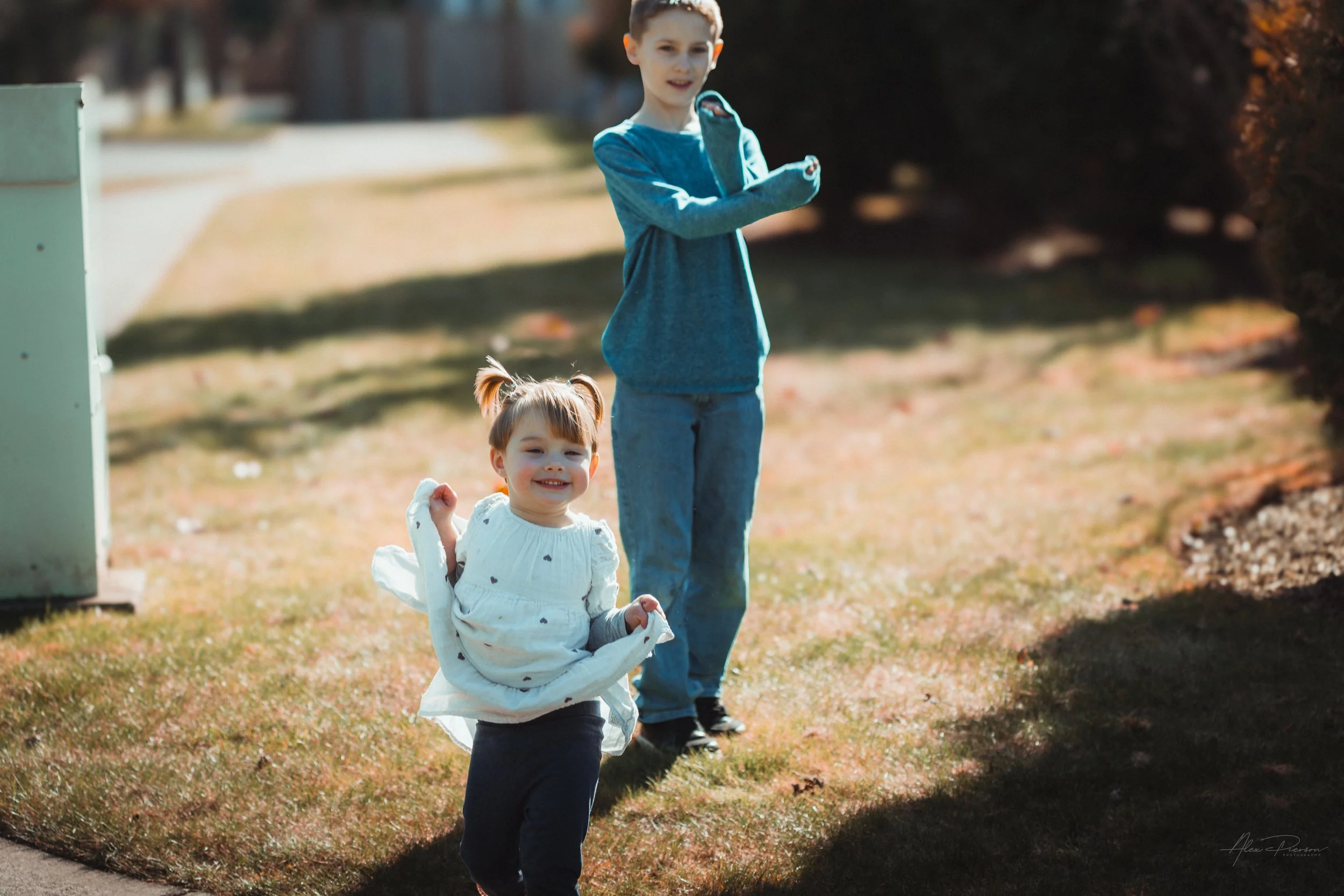 Little girl playfully making silly faces while running around  with her cousin during a candid family photo session Tumwater, WA – Pacific Northwest lifestyle family and children's photography.