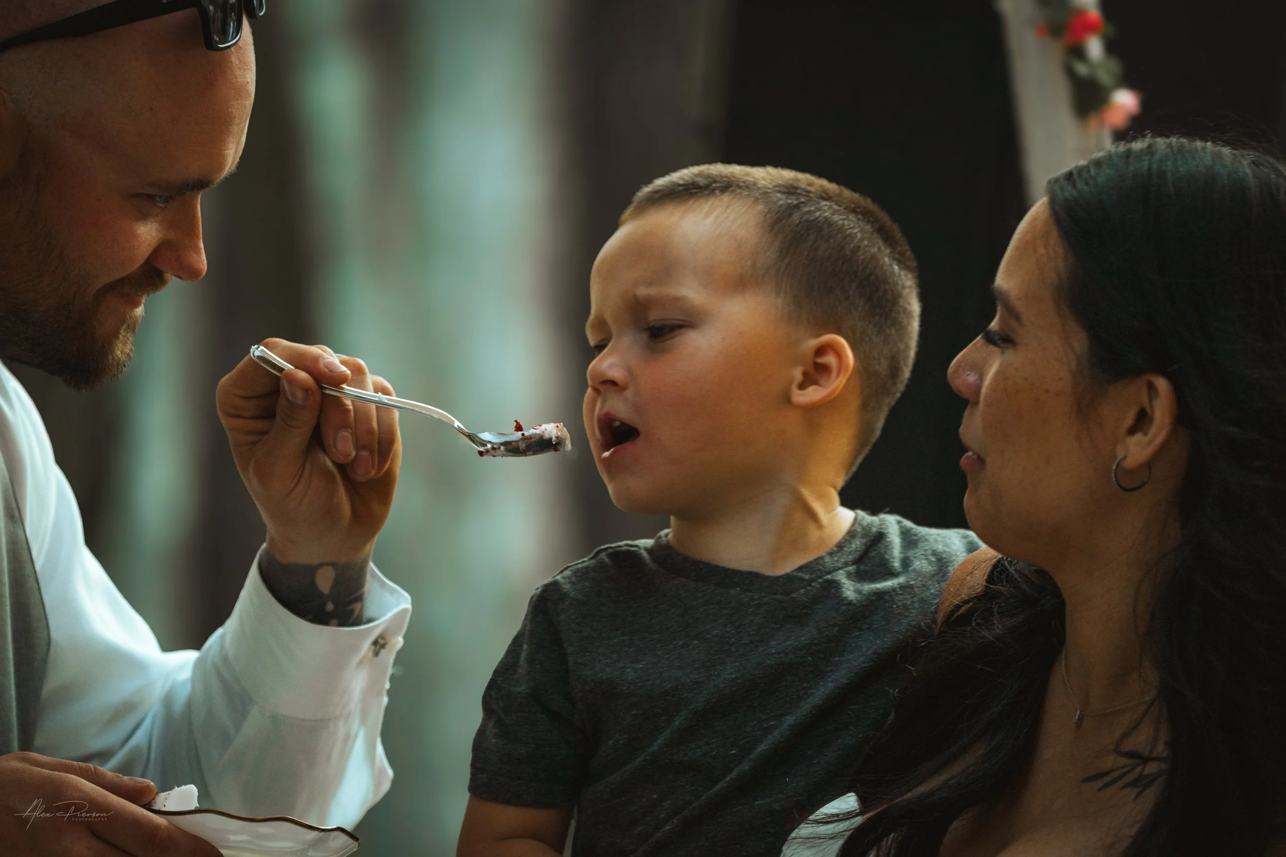 groom feeding his son cake during his wedding in Olympia, wa.