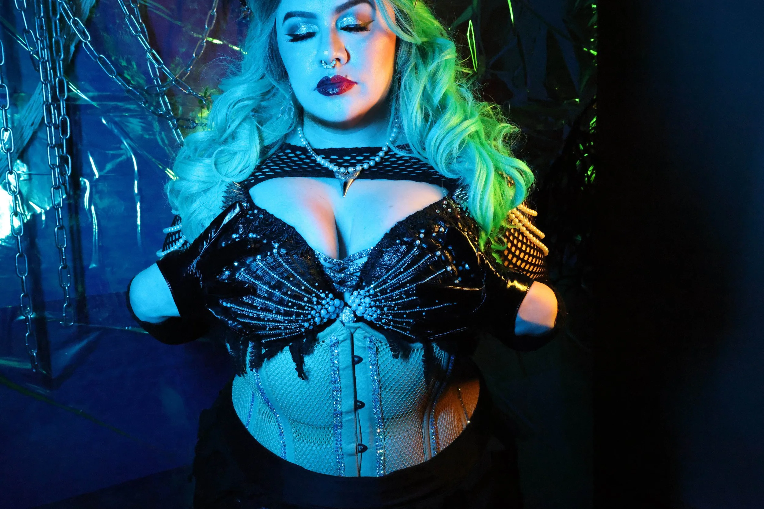 MerDomina closes her eyes and shows off Her handmade shell bra in turquoise hair and red lips