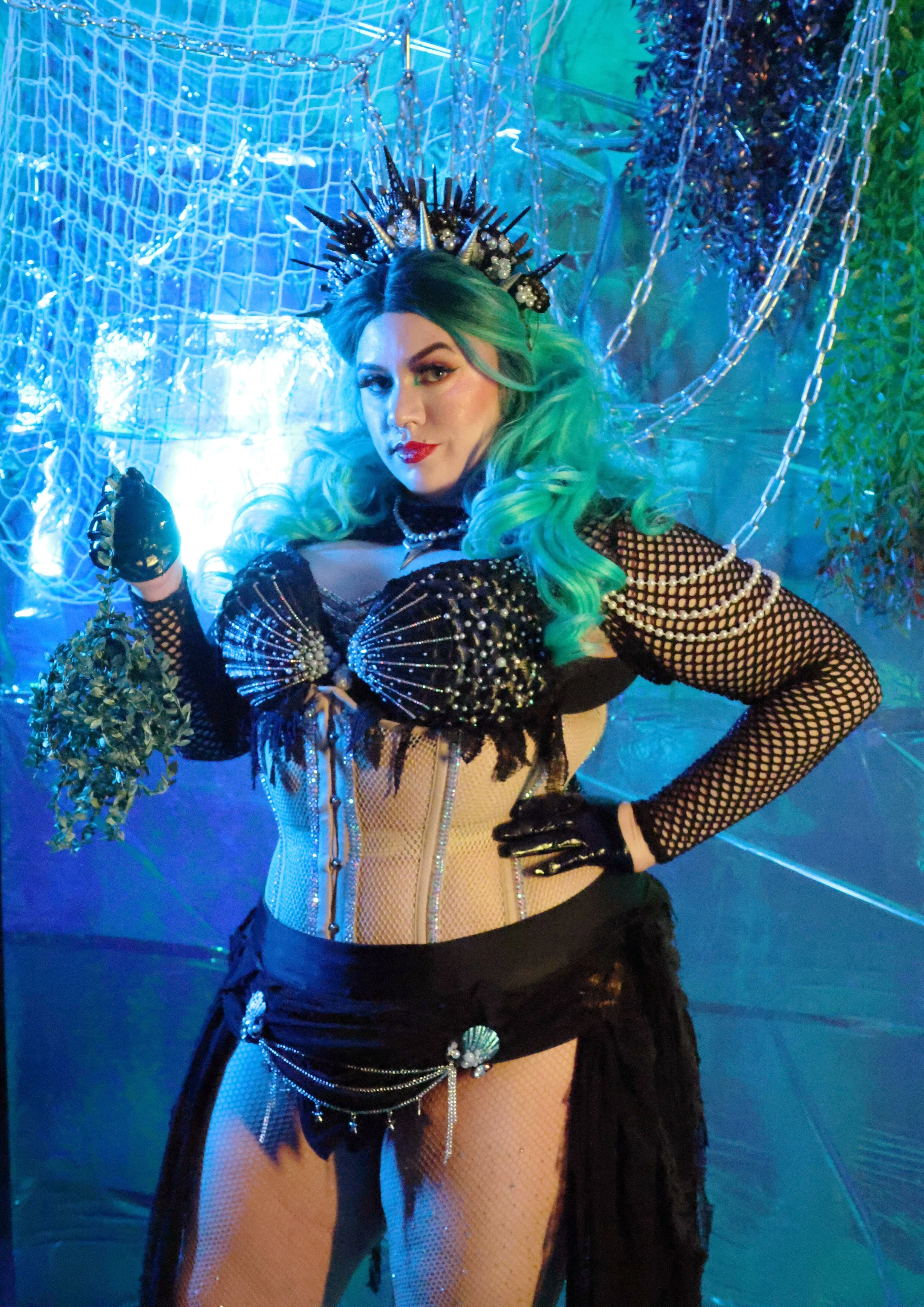 MerDomina holds Her hand-braided kelp rope in turquoise hair and a sparkly black mermaid burlesque-inspired costume