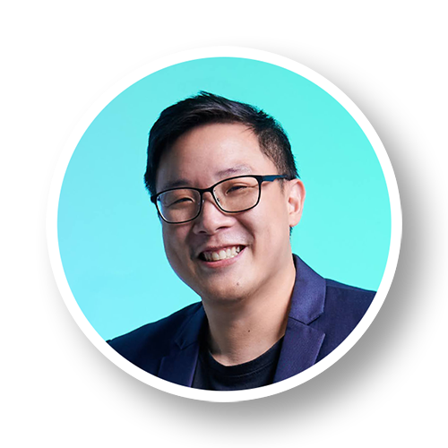 Headshot of a man with glasses smiling against a blue background