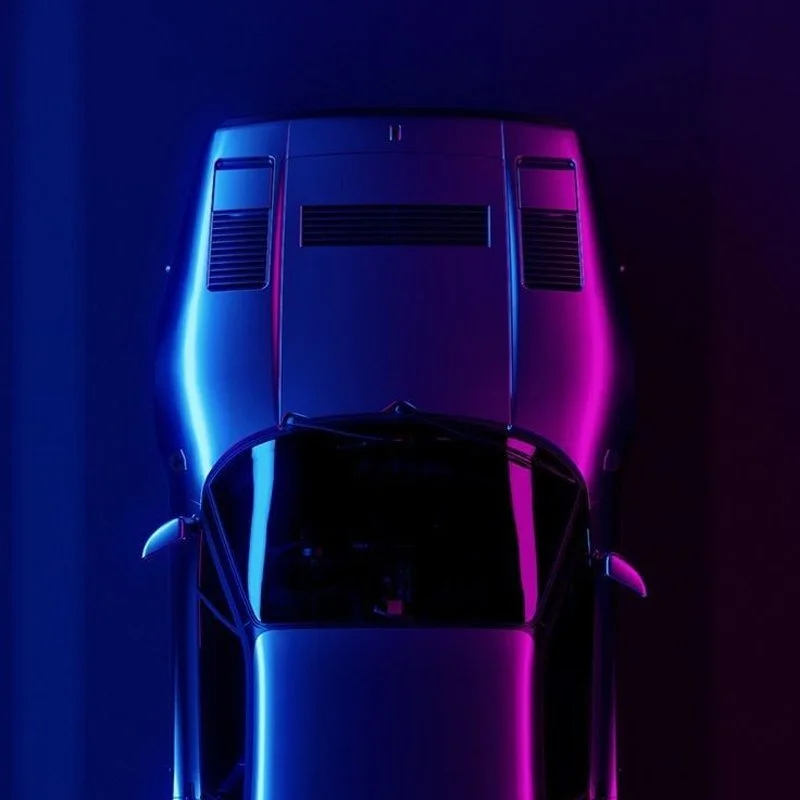 Top view of two sports cars illuminated by blue and pink neon lights in a dark environment.