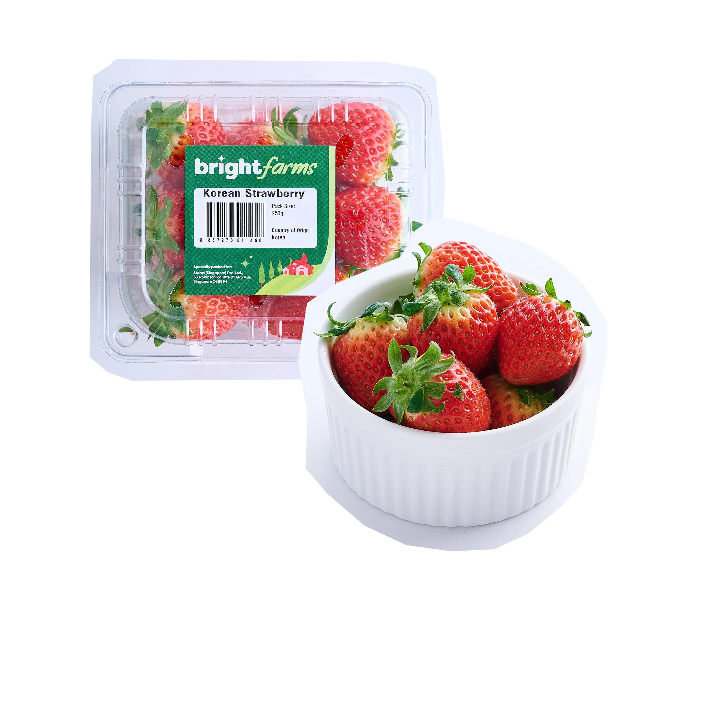Fresh red strawberries in a white ceramic bowl and a plastic container of strawberries with a label reading 'Bright Farms Korean Strawberry'.