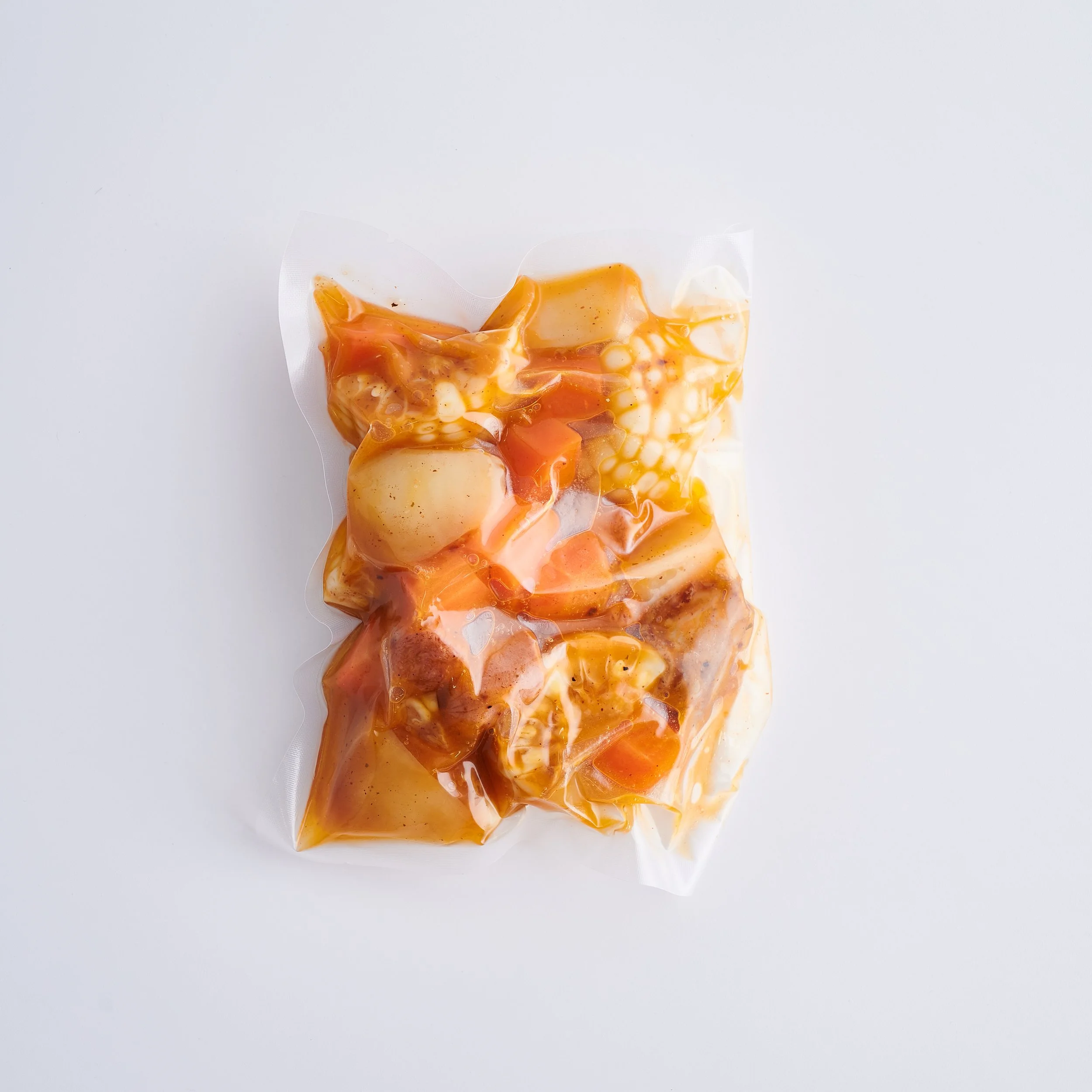 Raw chicken in vacuum-sealed packaging with sauce or marinade