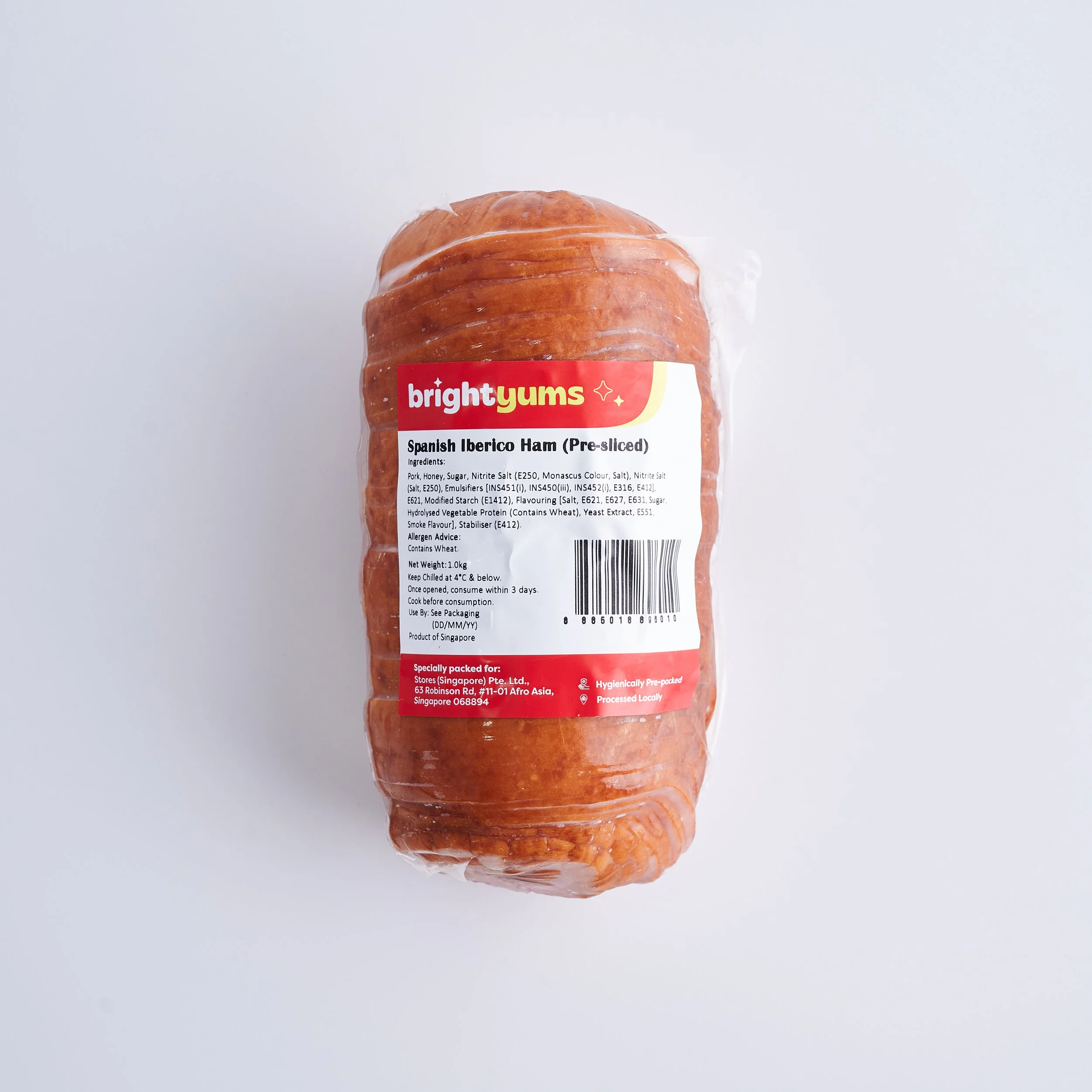 Packaged Spanish Iberico ham in clear plastic wrapping with Bright Yums label on a white surface.