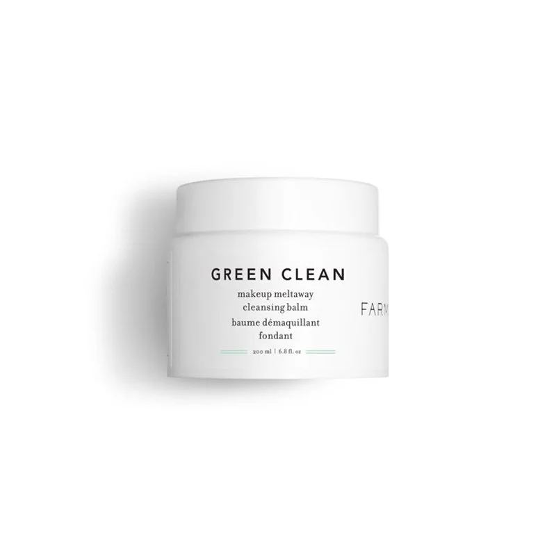 A white jar of Green Clean makeup meltaway cleansing balm by Farmacy with a white lid, on a plain white background.
