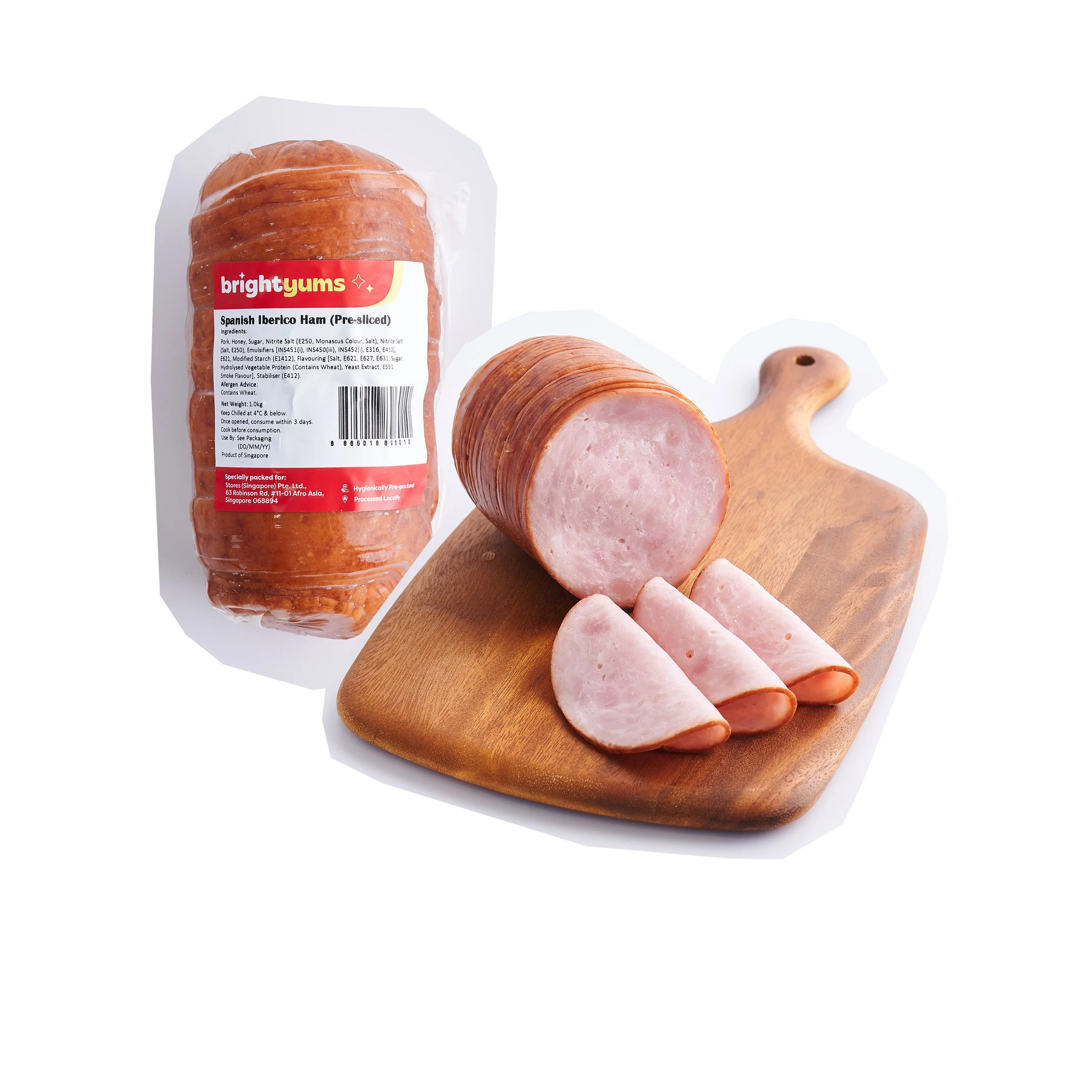Pre-sliced Spanish Iberico ham on a wooden cutting board with some slices laid out, next to a sealed package of ham labeled Bright Gums.