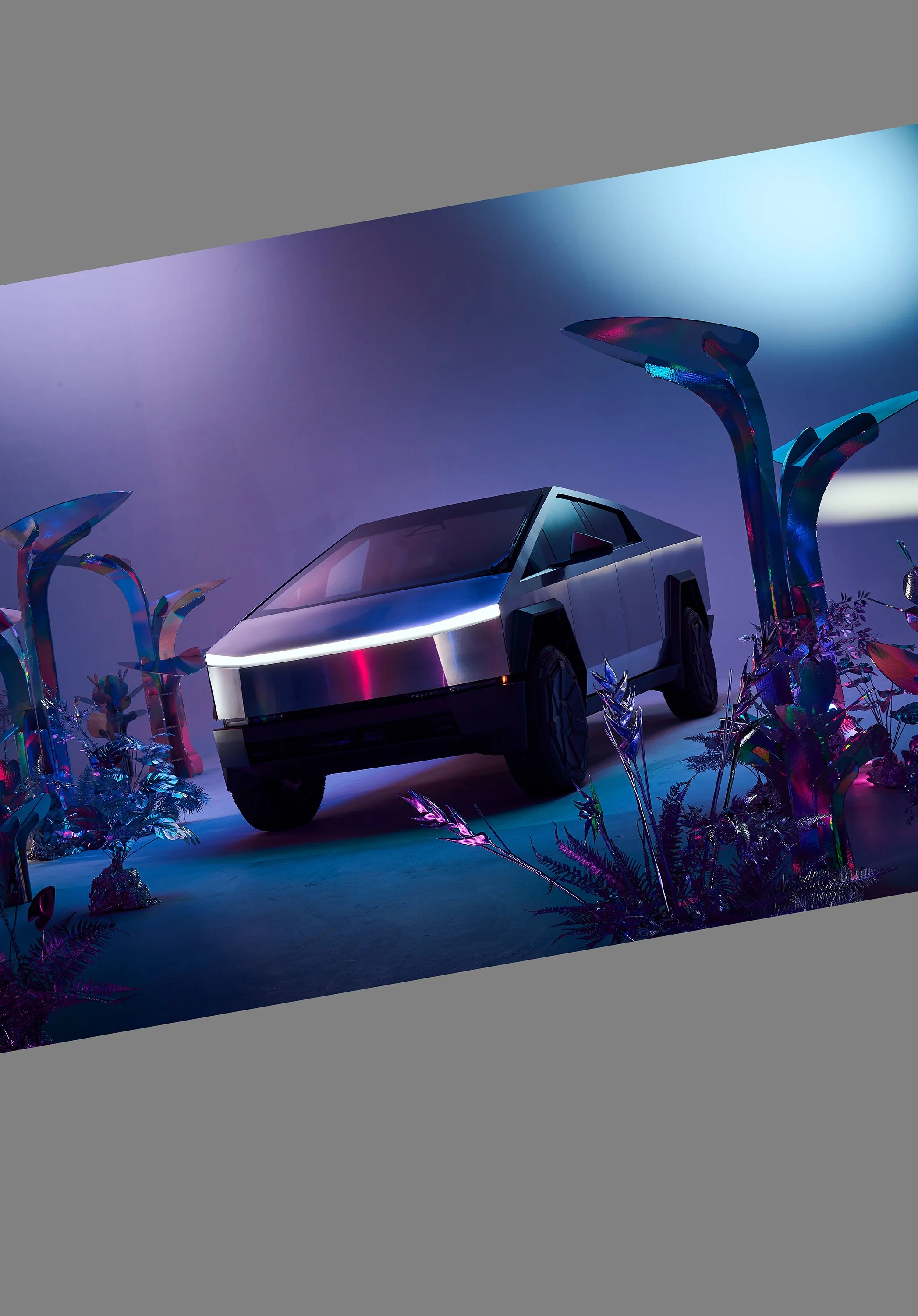 A futuristic, metallic silver SUV in a vibrant, colorful, surreal environment with large abstract plants and a glowing purple-blue background.