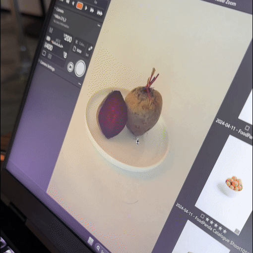Close-up of a tablet screen displaying a food photography editing app with a beet and radish on a white plate.