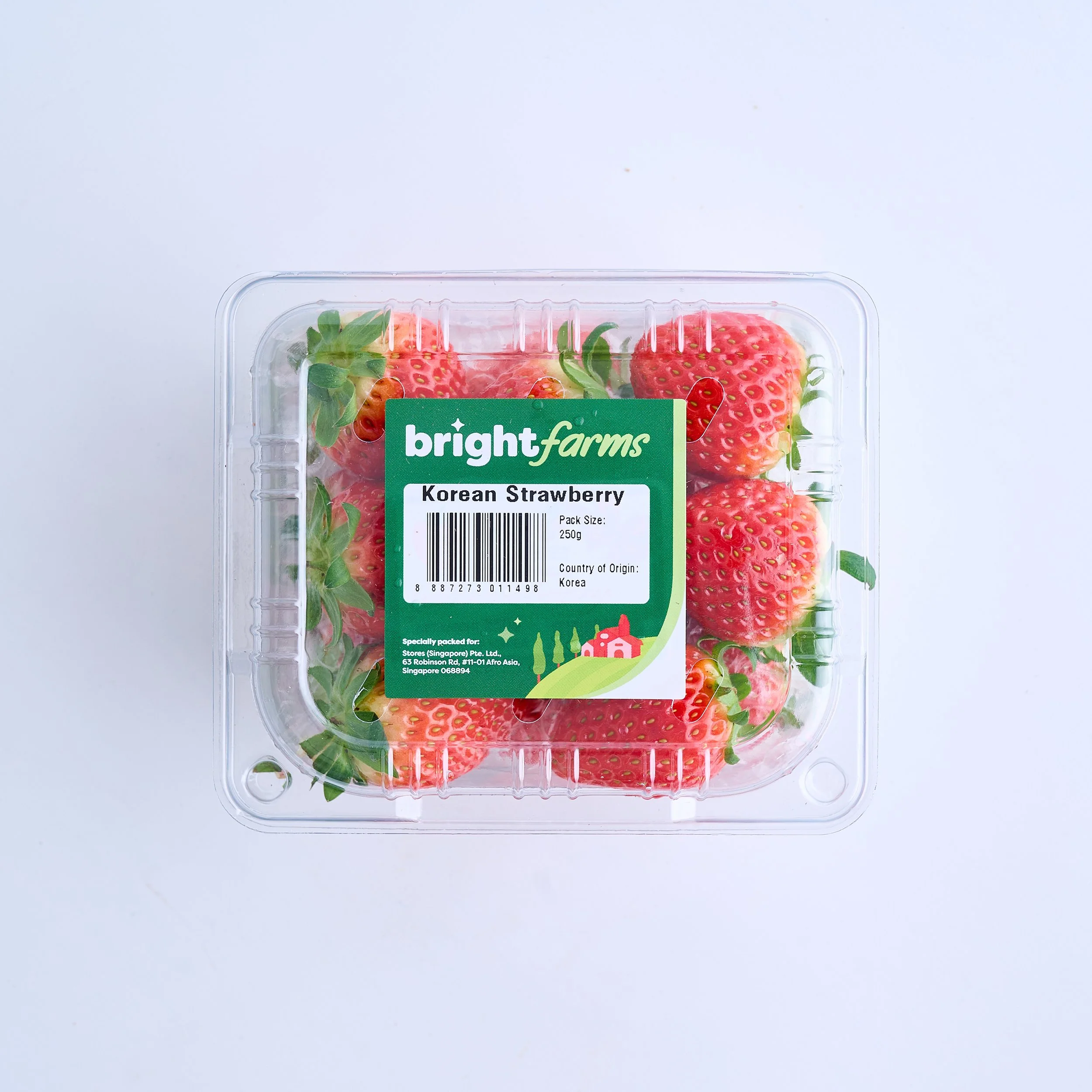 A clear plastic container filled with fresh Korean strawberries, labeled with a green sticker from Bright Farms.