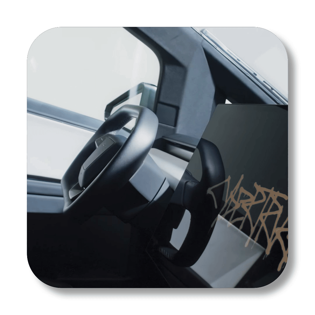 Close-up of a steering wheel inside a vehicle with a digital display showing a graffiti-style design.