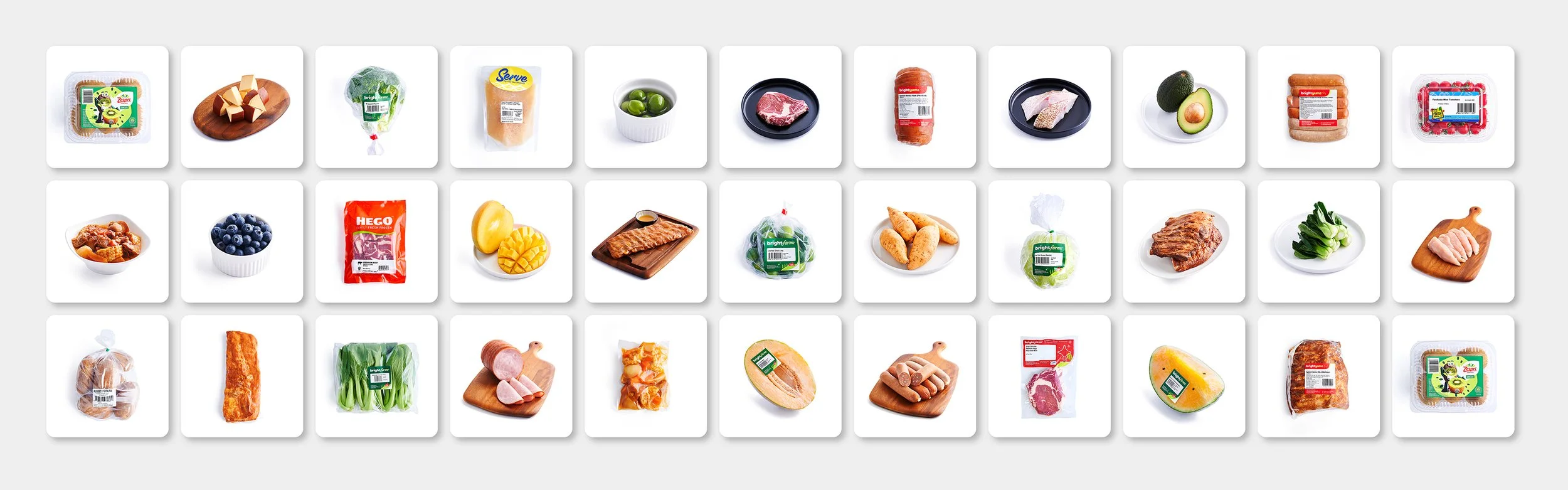 Array of various packaged food items including vegetables, meats, fruits, and prepared meals.