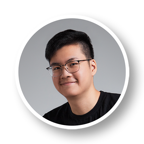 Portrait of a young man with glasses, short black hair, smiling, wearing a black shirt, against a gray background, framed in a circular border.