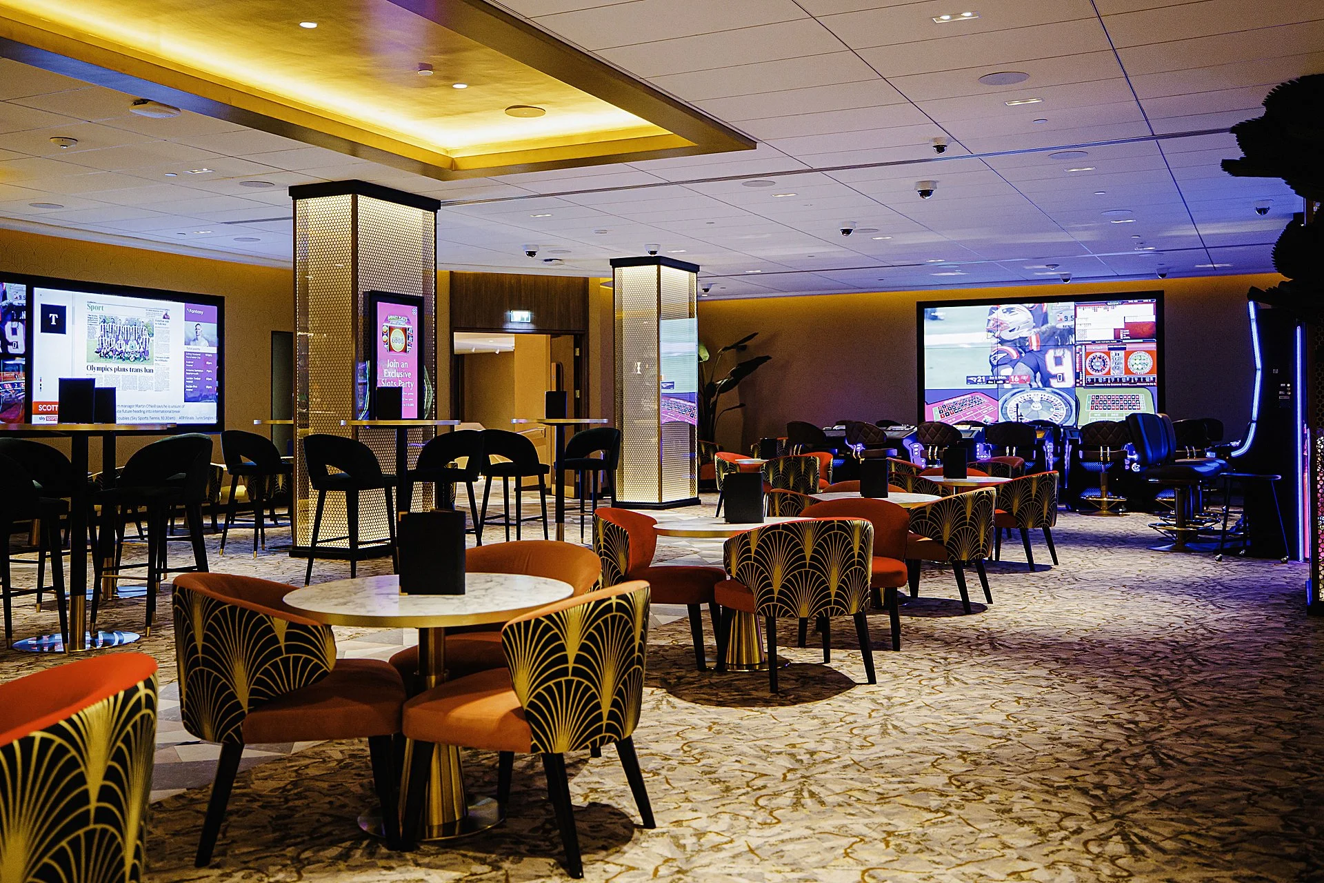 Wide shot of high and low tables with lounge chairs and barstools 