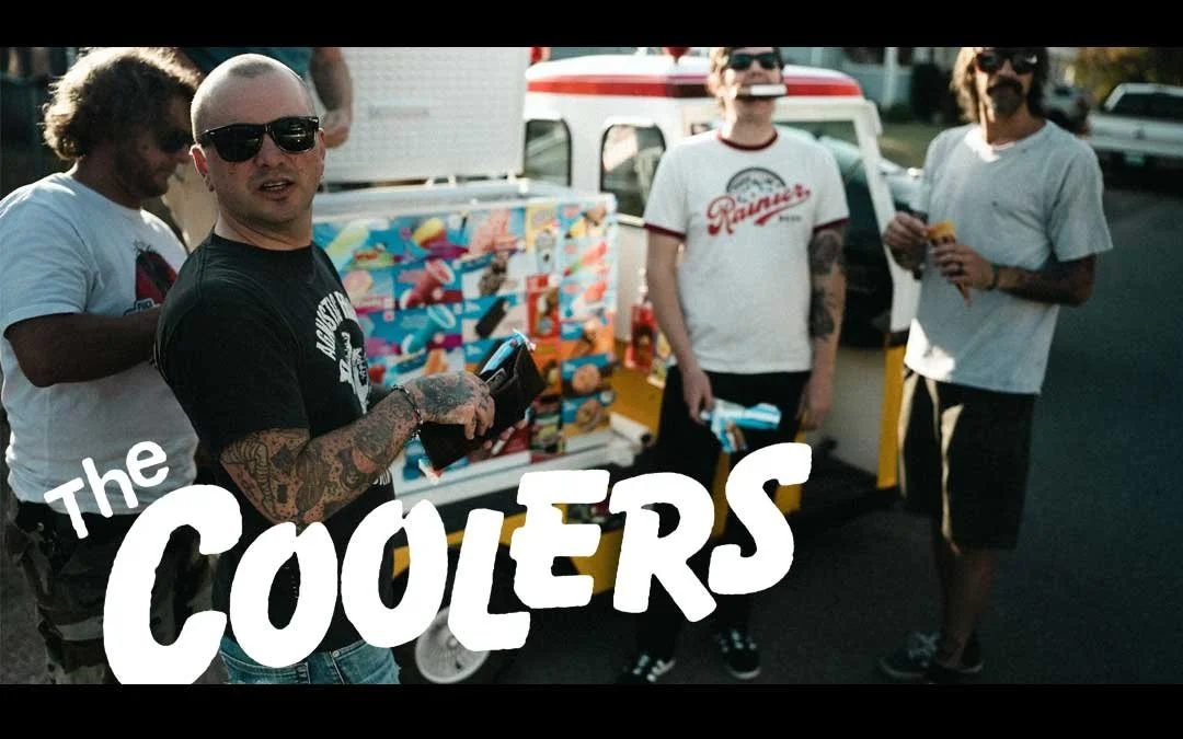 Four men standing outdoors next to an ice cream truck, with the text 'The Coolers' in large white letters across the bottom of the image.