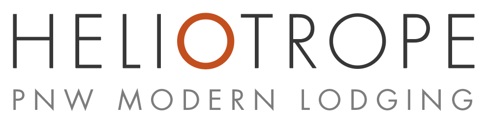 Logo for Heliotrope PNW Modern Lodging with stylized text and a circular element in the letter 'O'
