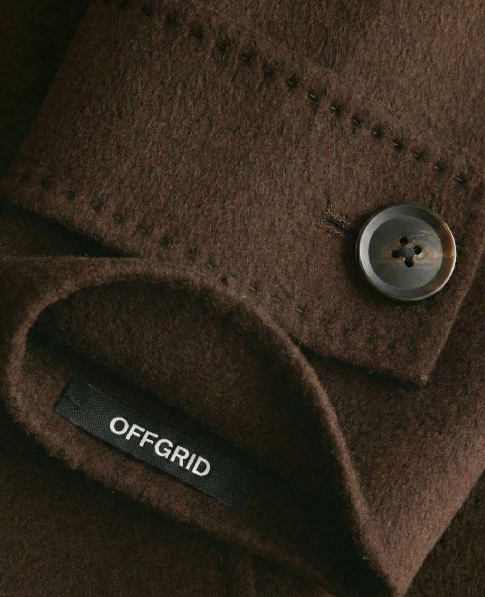 Garment sleeve label detail for OffGrid luxury clothing brand identity designed by BCLR.