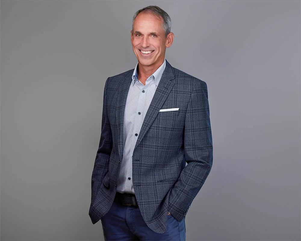 Executive portrait of John Huttinger photographed in Irvine for The Baldwin Group during a large on-location corporate headshot session. This professional business portrait was created for LinkedIn, company website, and personal branding use. Alex Ab