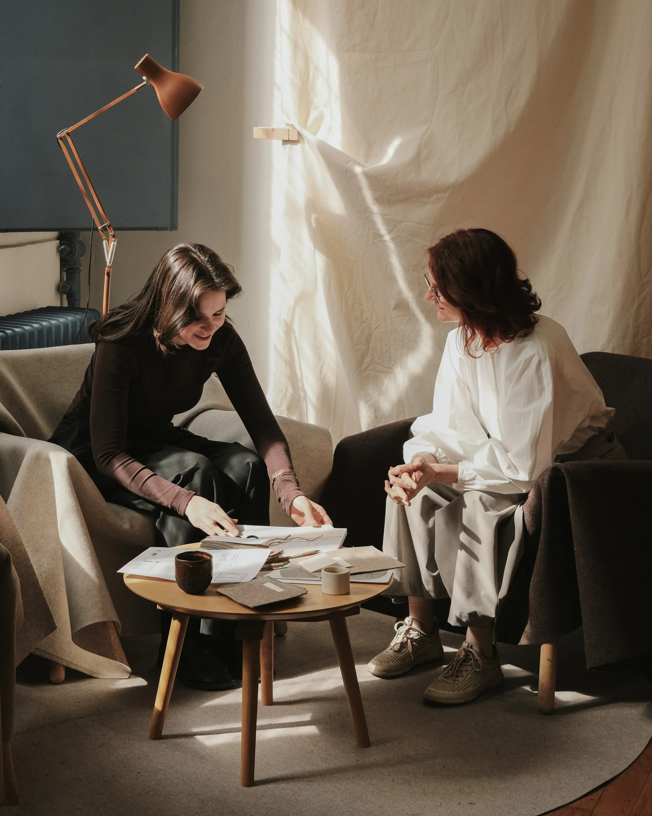 Hello from the studio.
Sara and Alenka working on a new soft object.
Sketches, felt samples, paper mock-ups and afternoon light. Any guesses what they&rsquo;re working on?
Photography: @hana.jelovcan 
#KaaitaStudio #SoftObjects #KaaitaDreamTeam