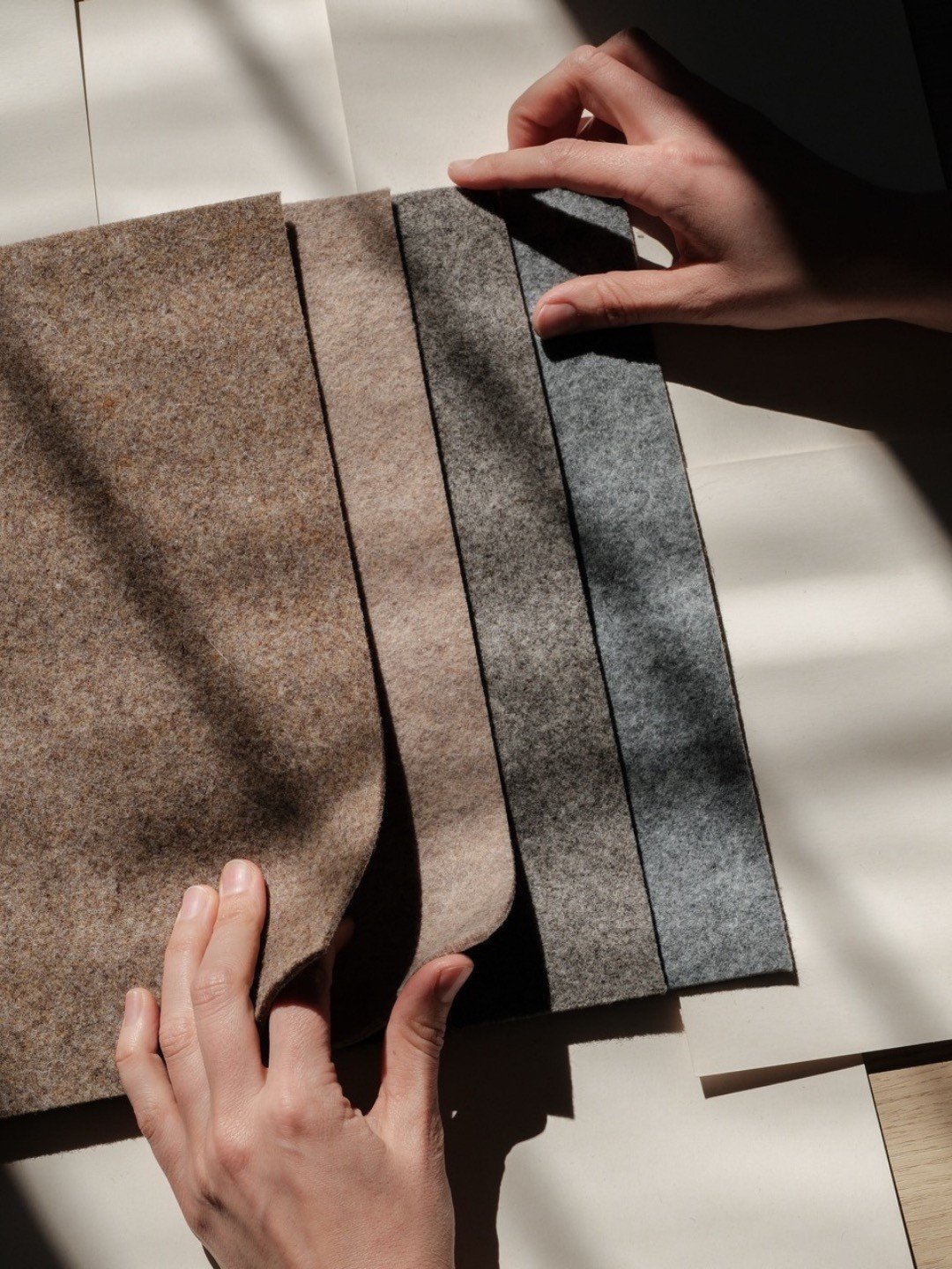 Considered materials carry meaning.
How are the fibres brought together?
What stories do they carry?
What values shape the hands that make them?
In these photographs, you can see four of our favourite felts.
Three are undyed, meaning their colours al