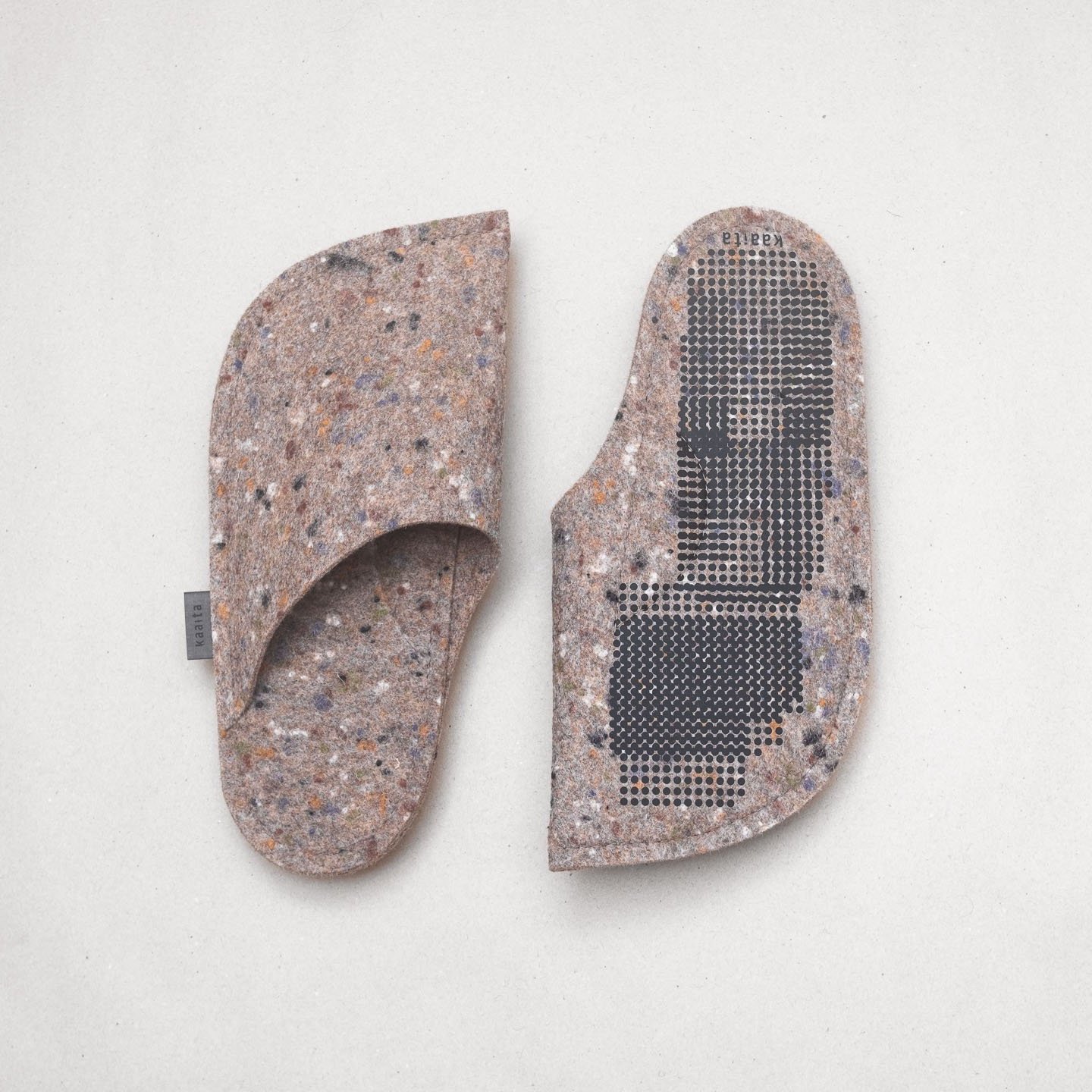 Kaaita beige non-slip wool slippers with spots made from recycled woolen pullovers, featuring lavender flowers sewn into the soles for a soothing massage and added comfort.