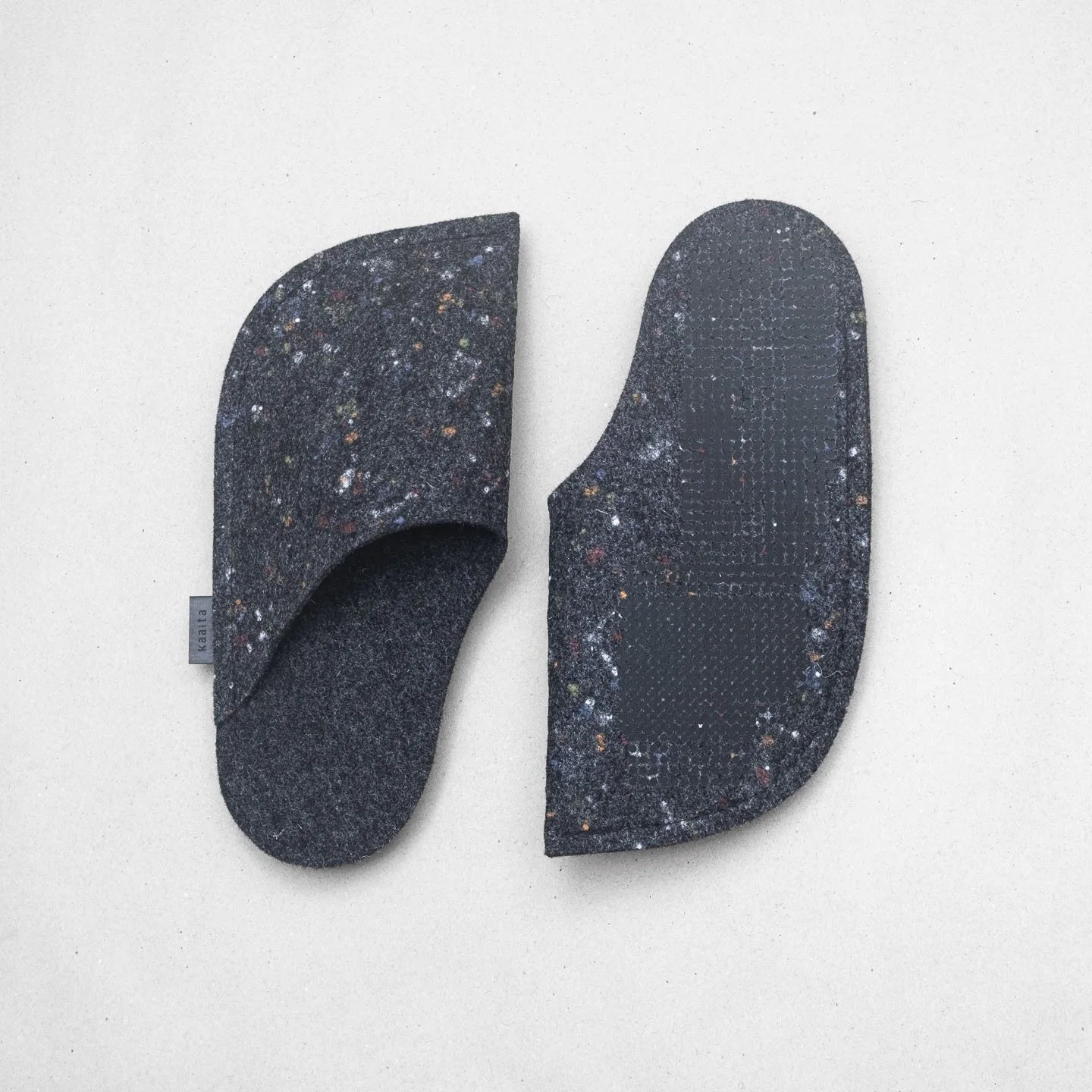 Kaaita black non-slip wool slippers with spots made from recycled woolen pullovers.