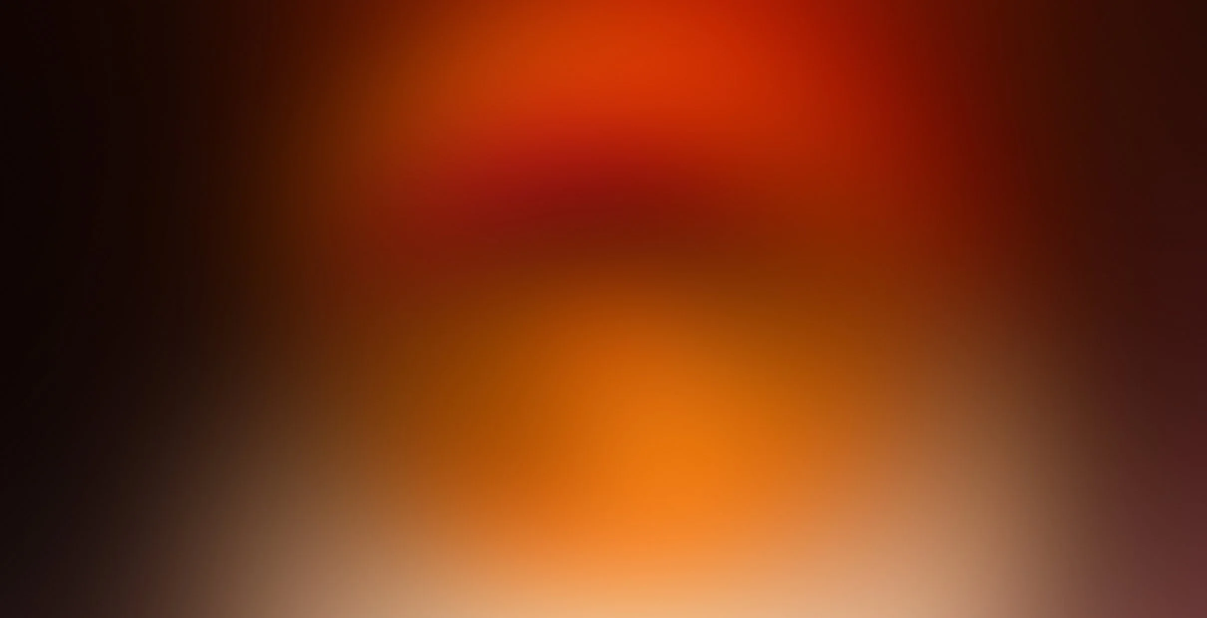 A blurred metallic surface with a gradient of gray tones.