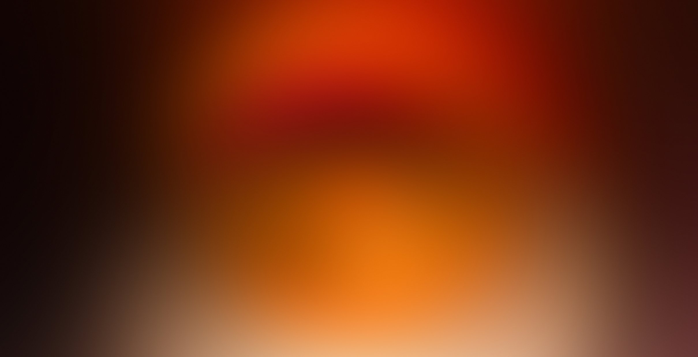 Blurred gradient background of orange and red hues.