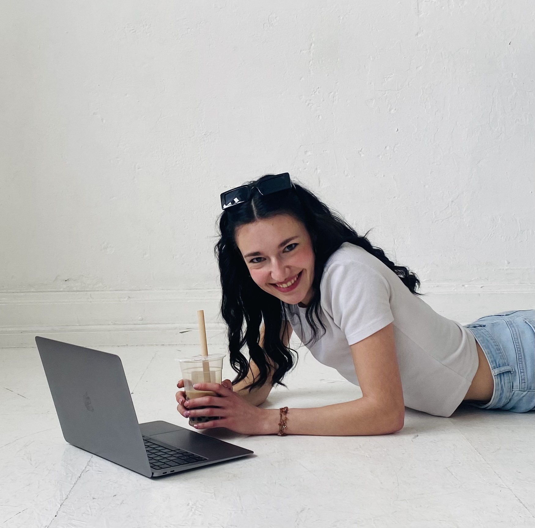 Virtual Assistant Marina sitting at a laptop and smiling at the camera