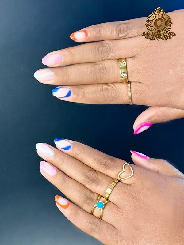 Colorful nail art with gold rings on hands