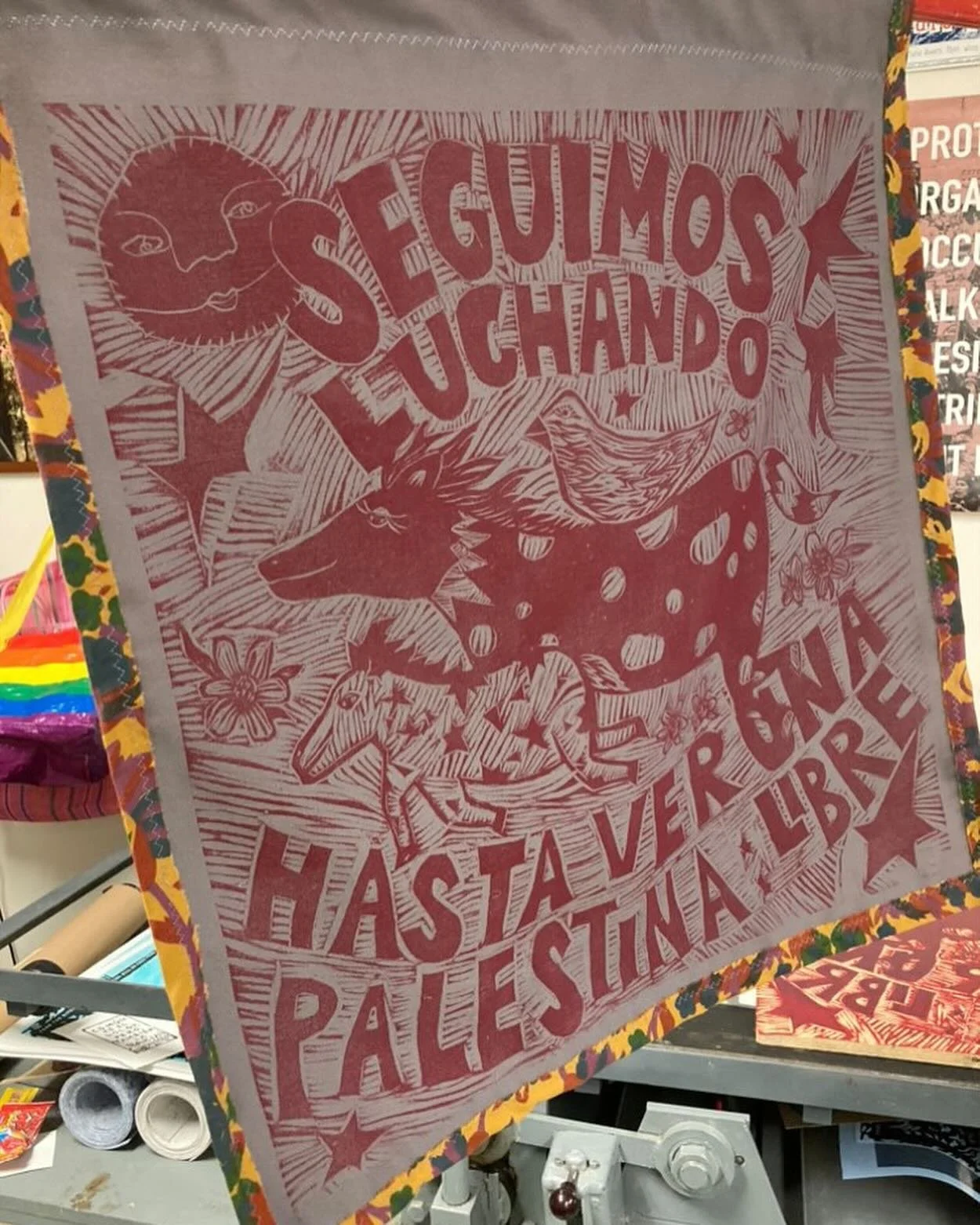 Banners by @graficanarno  made to raise money for e-sims and stock art supplies. 

This is a woodblock carving that reads SEGUIMOS LUCHANDO HASTA VER UNA PALESTINA LIBRE / WE KEEP FIGHTING UNTIL WE SEE A FREE PALESTINE 🍉

Red ink printed on fabric a