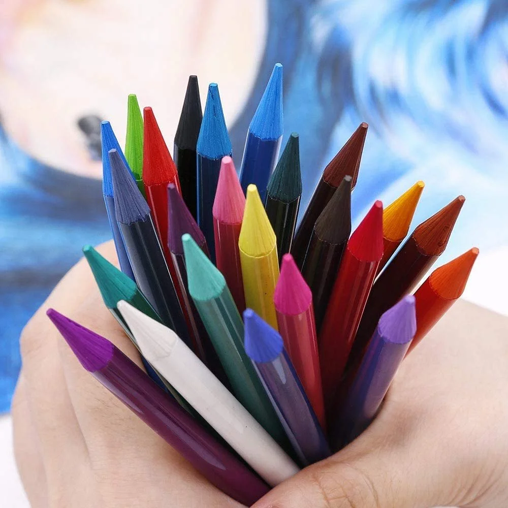 A hand holding a bunch of colorful colored pencils.