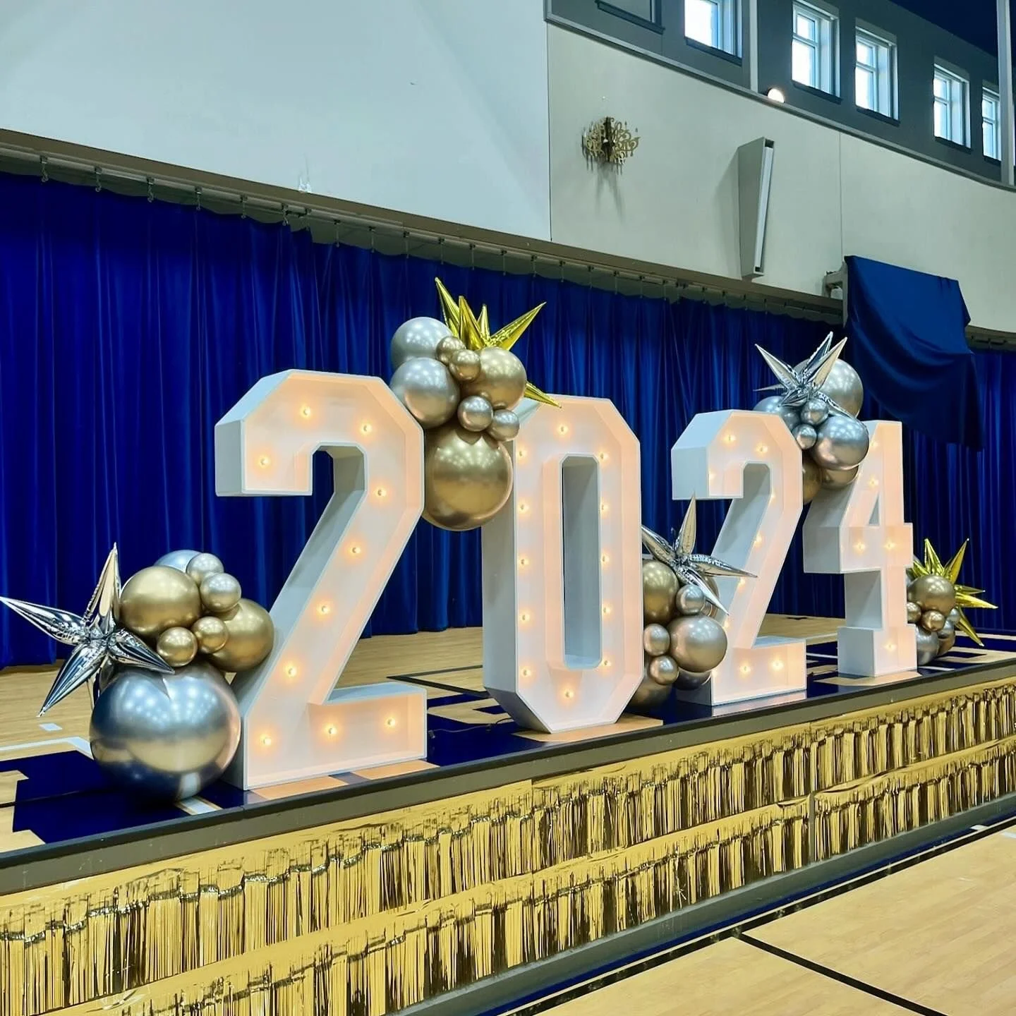 marquee numbers with balloon clusters and foils