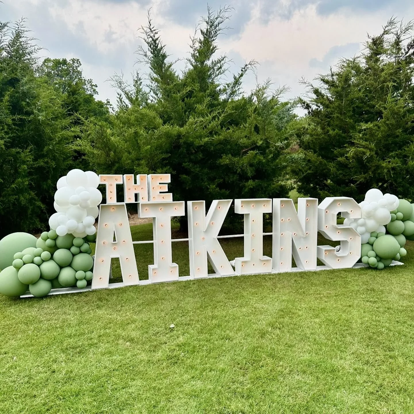 marquee letters with balloon clusters