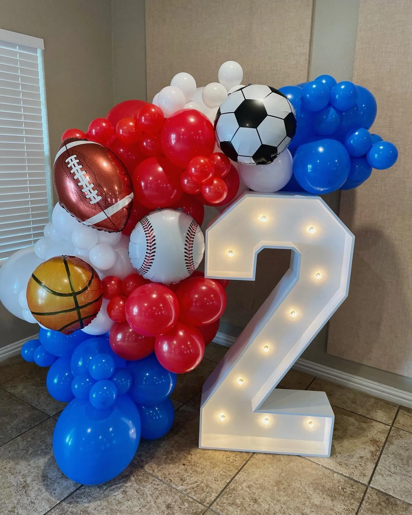 marquee number 2 with balloon garland and sports foils