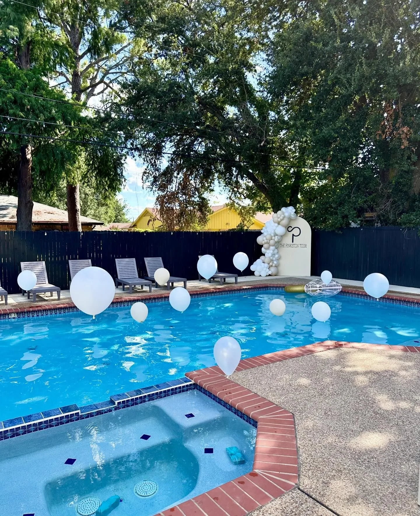 helium balloons in pool and 7x4 wood arch backdrop with vinyl, 8-10 ft balloon garland