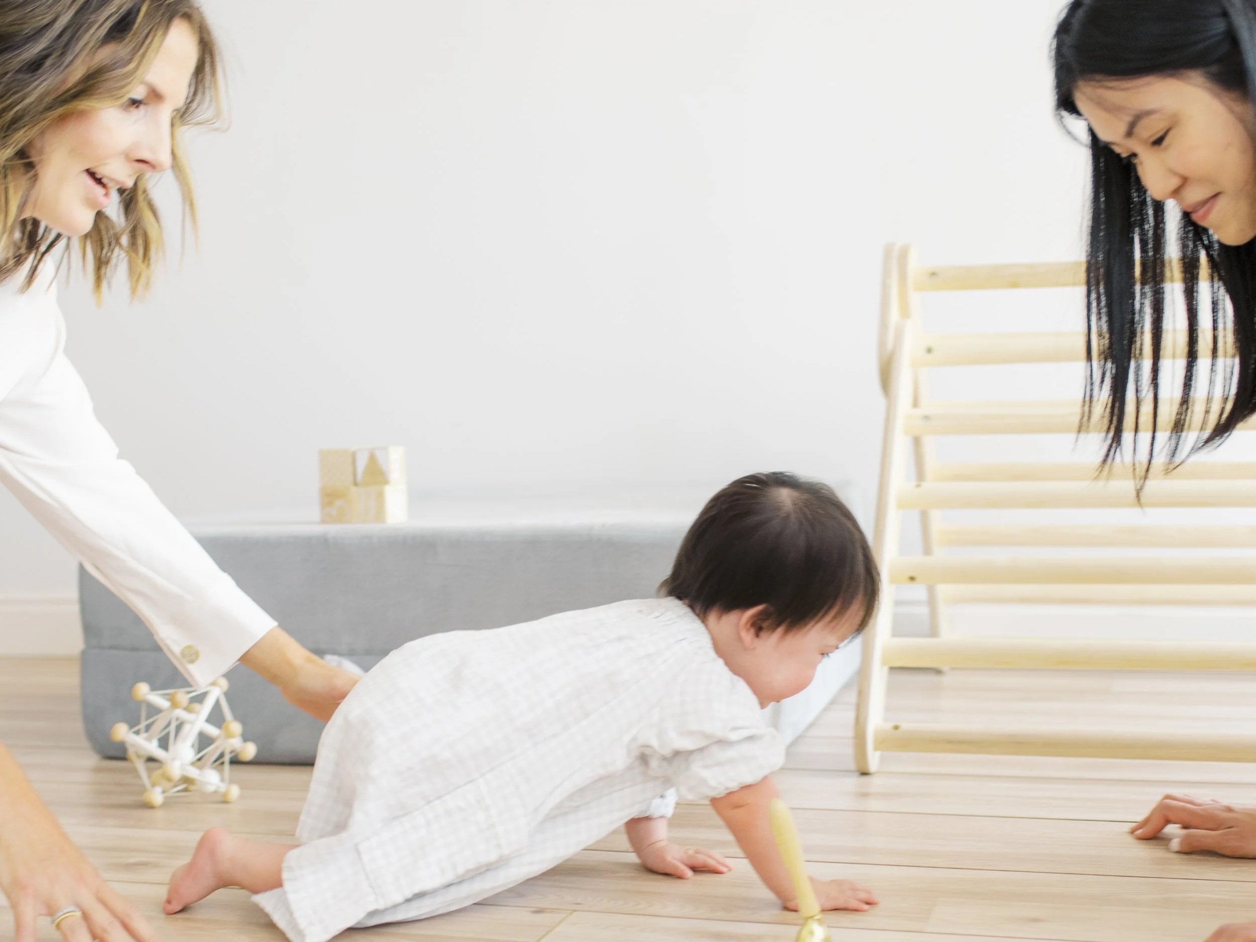 Baby crawling forward on hands and knees, developing strength and coordination.