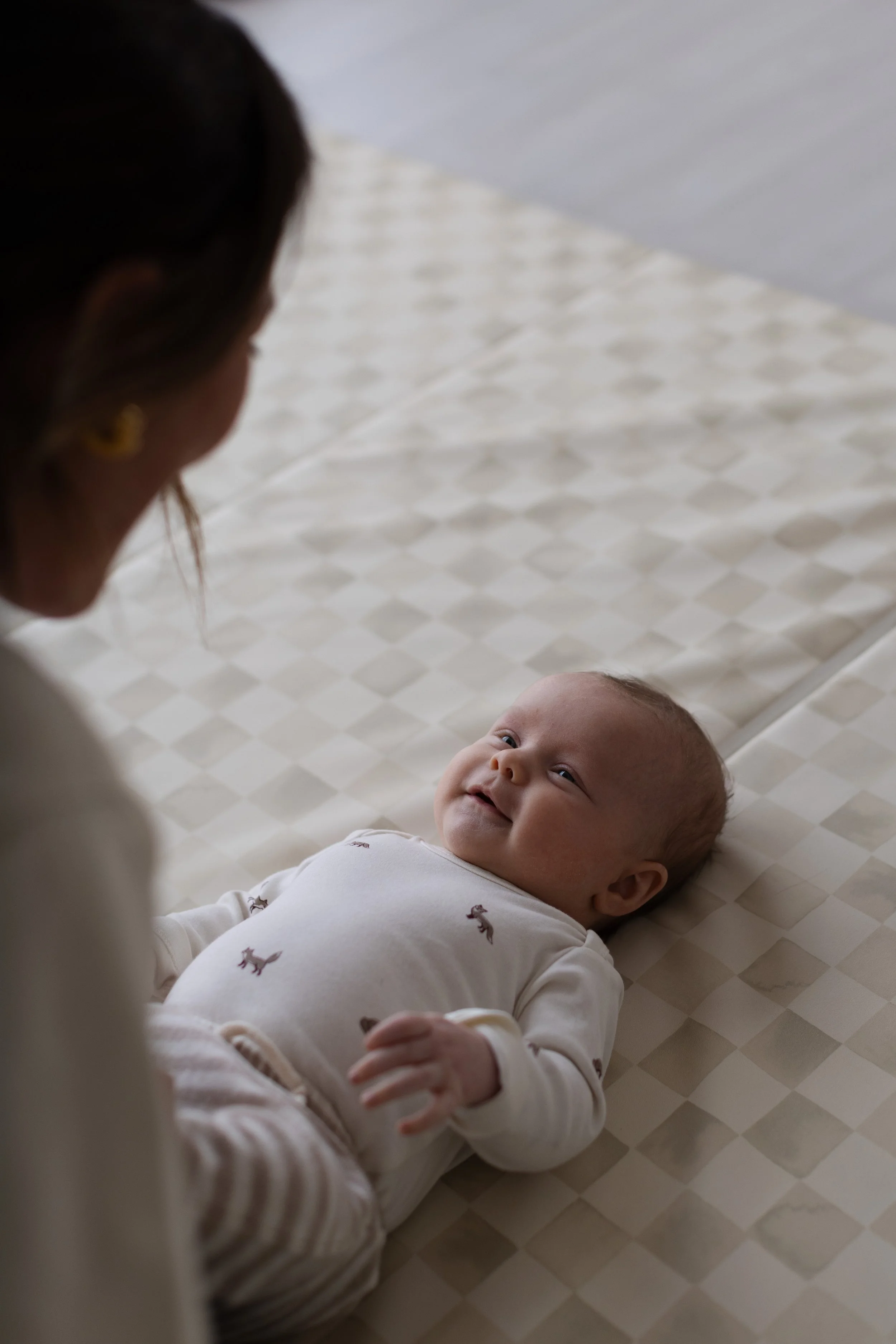 Pediatric physical therapist and baby sharing a calm, connected moment during a gentle therapy session at Movevery Denver