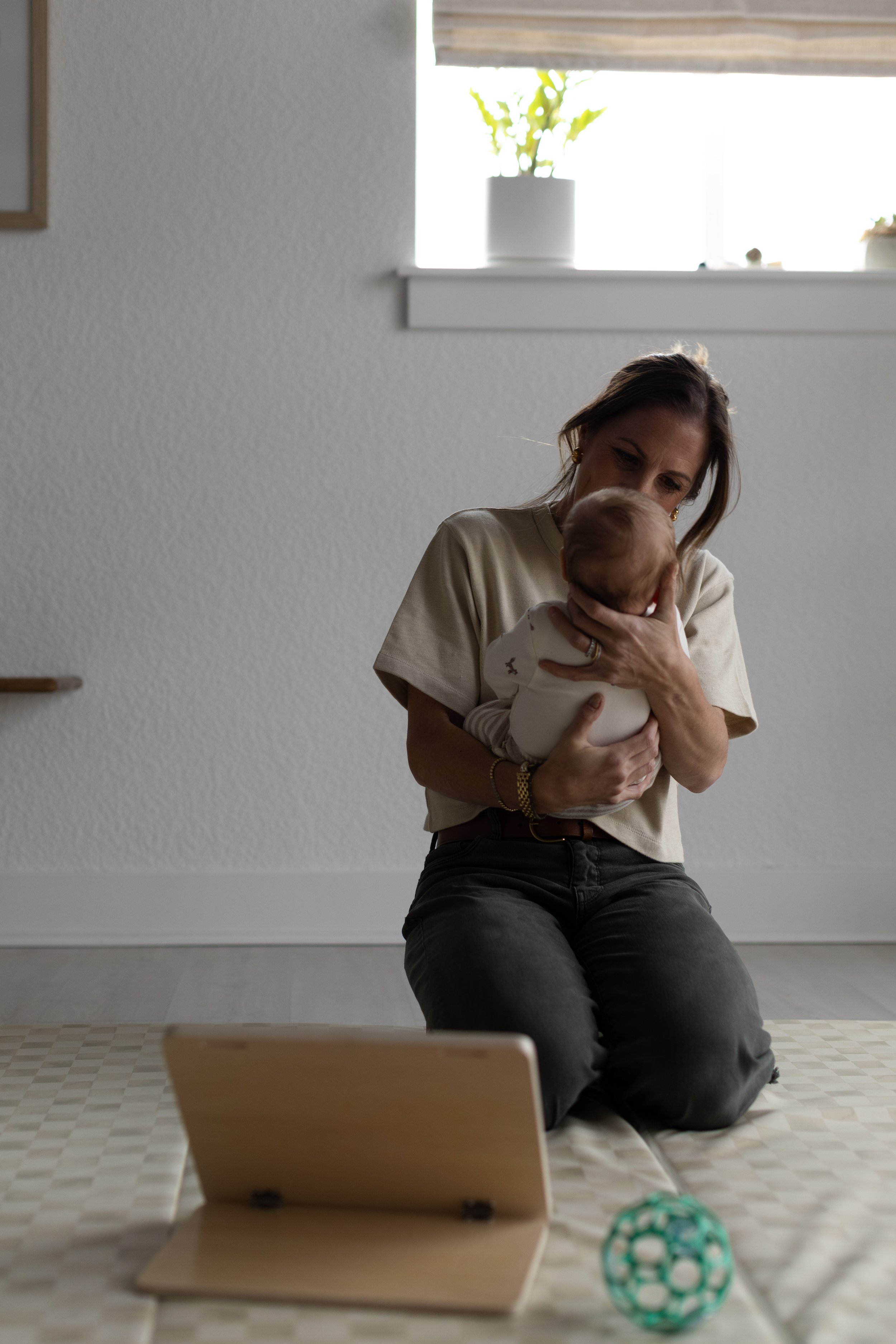 Pediatric physical therapist performing gentle manual therapy bodywork on an infant at Movevery PT Denver