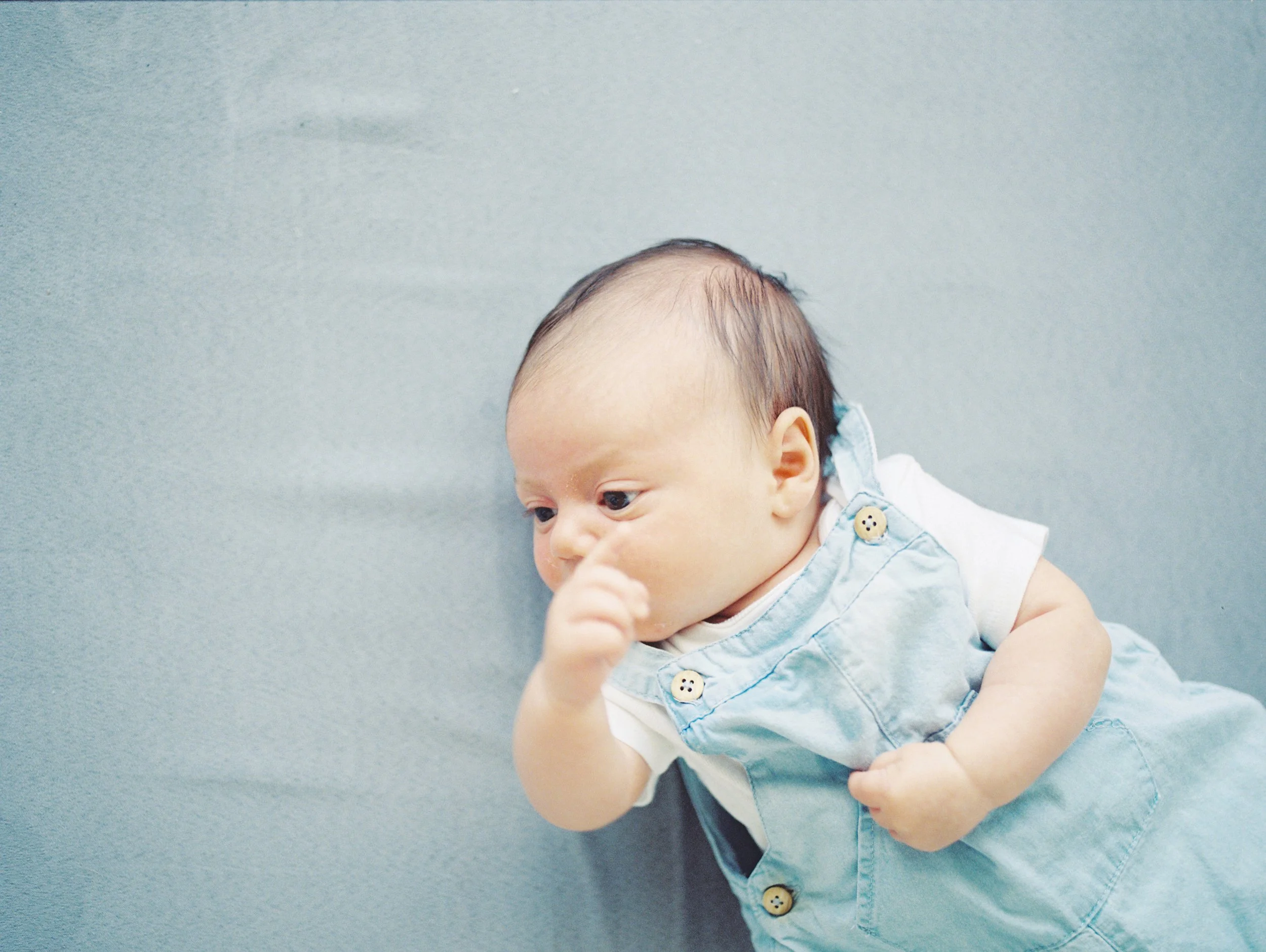 Infant demonstrating a head position preference, a common early sign of torticollis