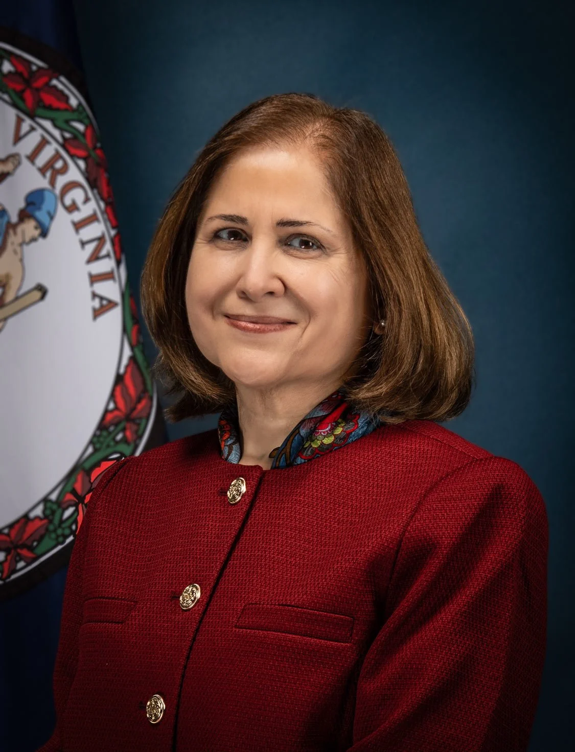 official portrail of woman smiling in red suit