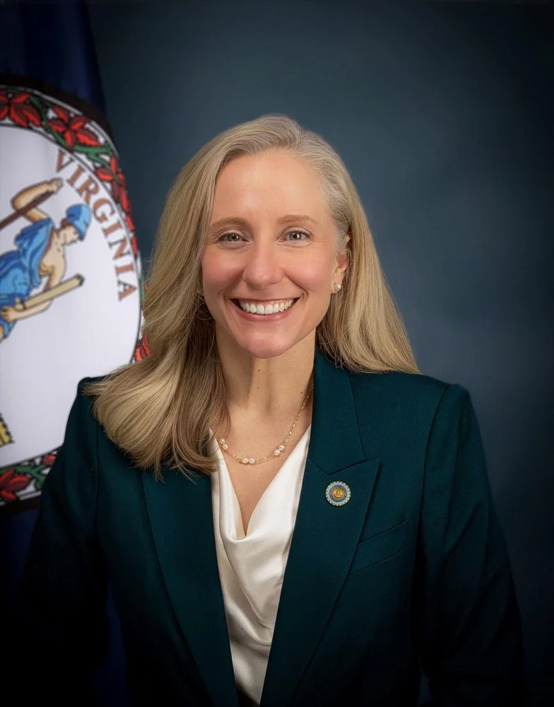 official portrait of woman smiling in blue suit