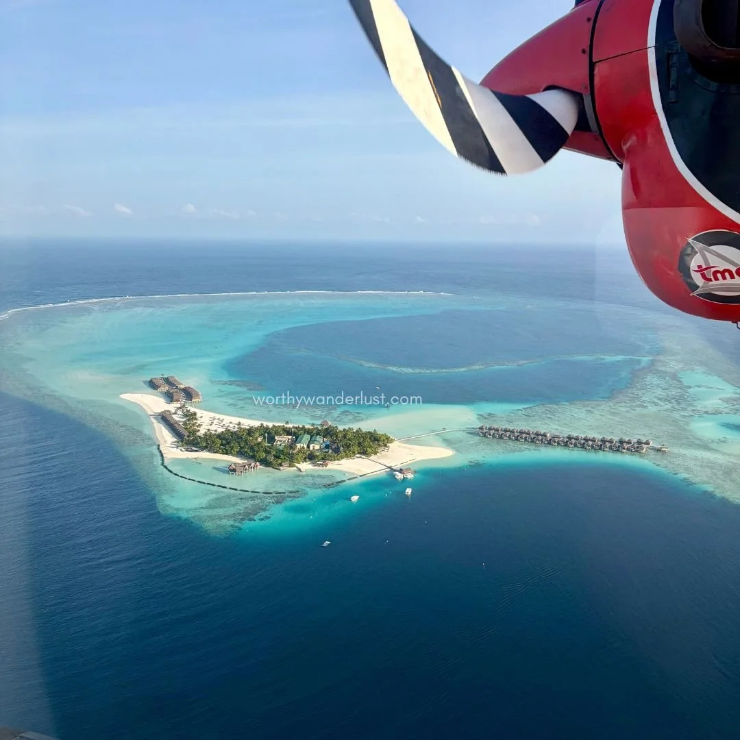 View of small island occupied by a luxury resort in Maldives, from a seaplane window