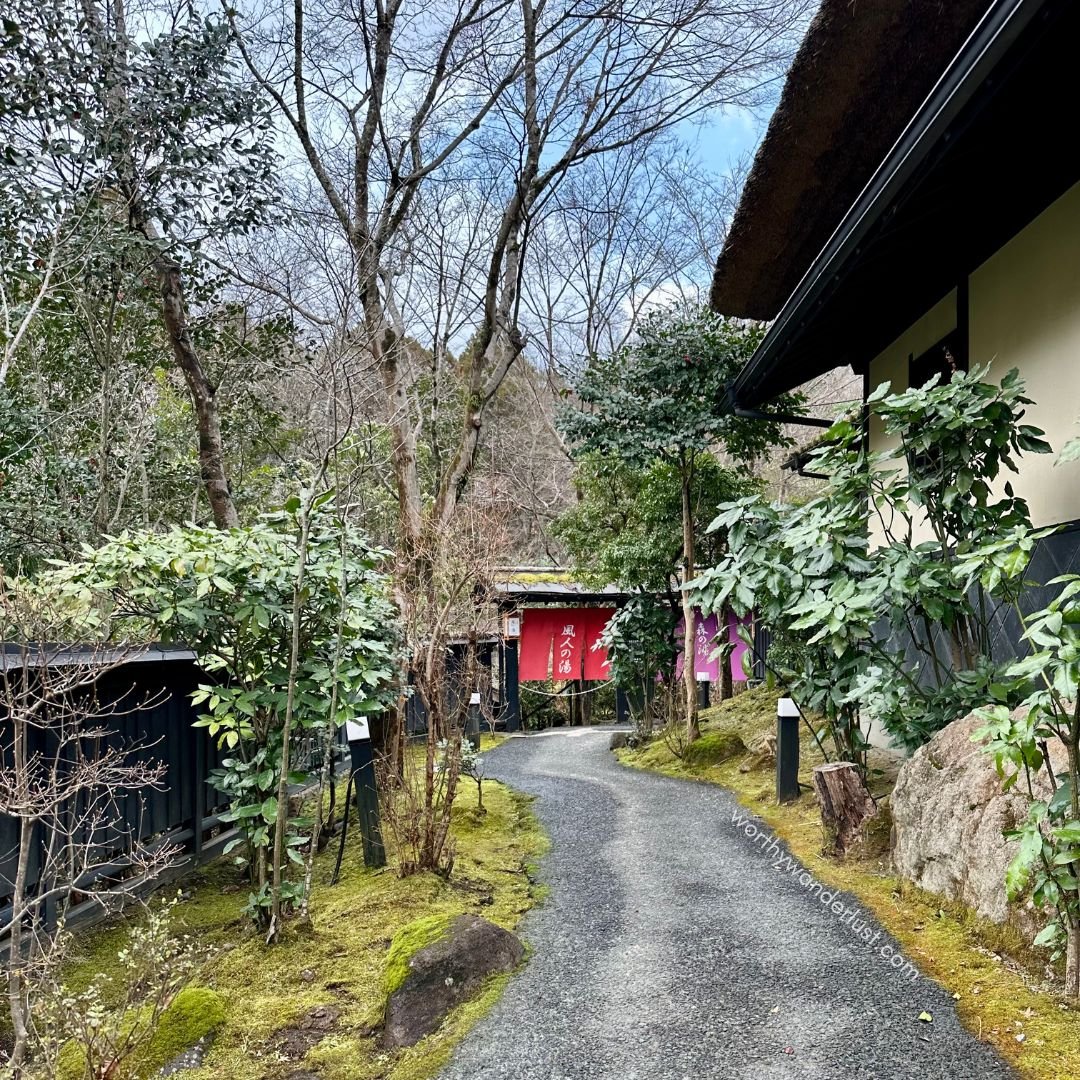 Pathway to onsen entrance curtains, with greneery at sides