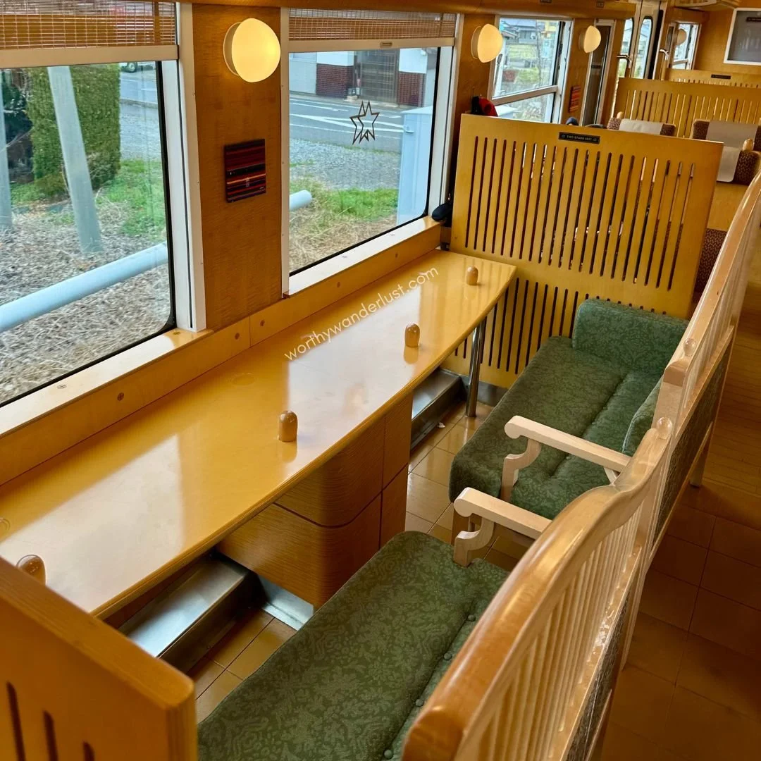 Sofas facing windows and counter table in a train