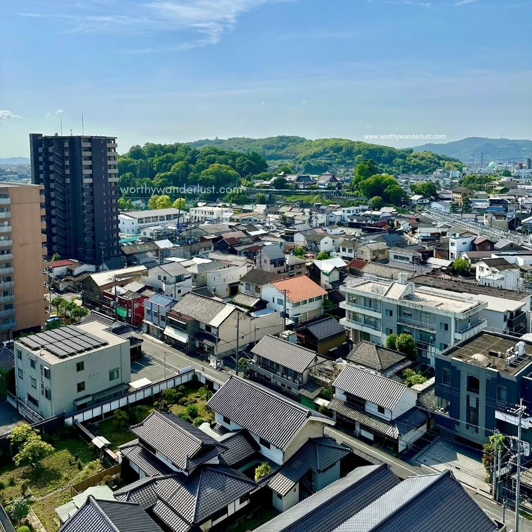 Expansive bird eye's view of Kurashiki with green hills in the distance
