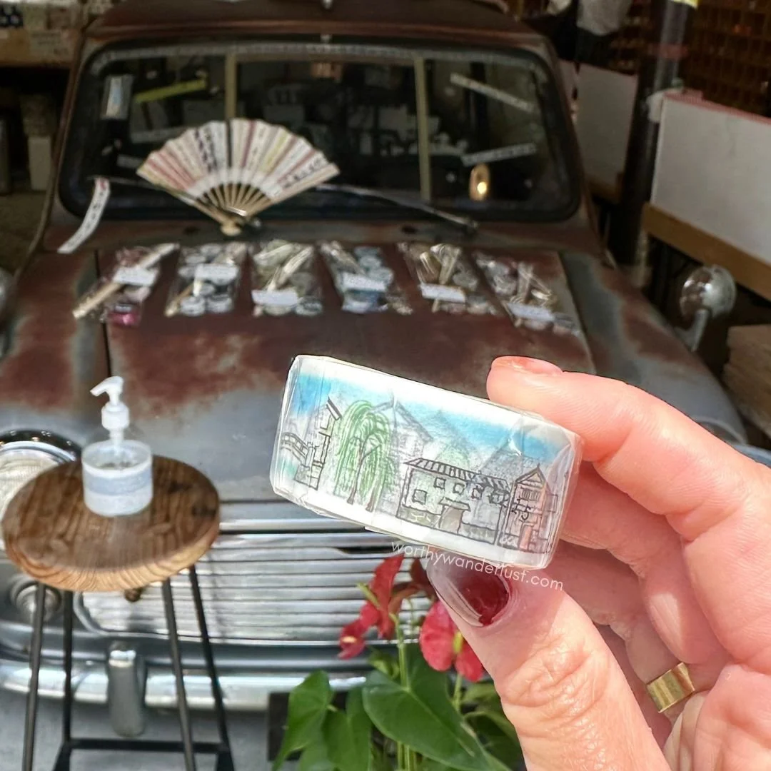 Hand holding up a washi tape with a Kurashiki-inspired design.