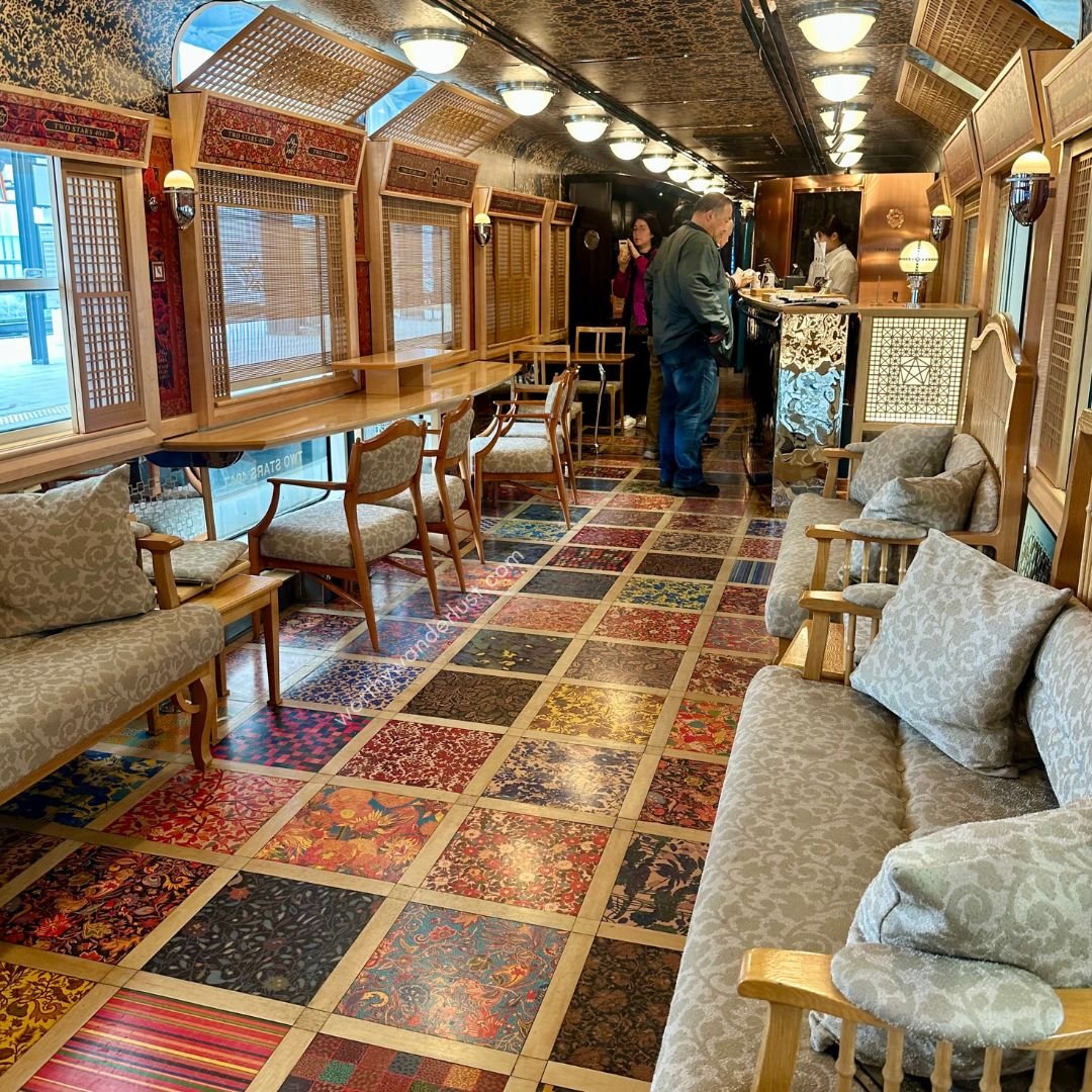 Stylish lounge with vibrant flooring, sofa seats, counter tables and lattice lamps