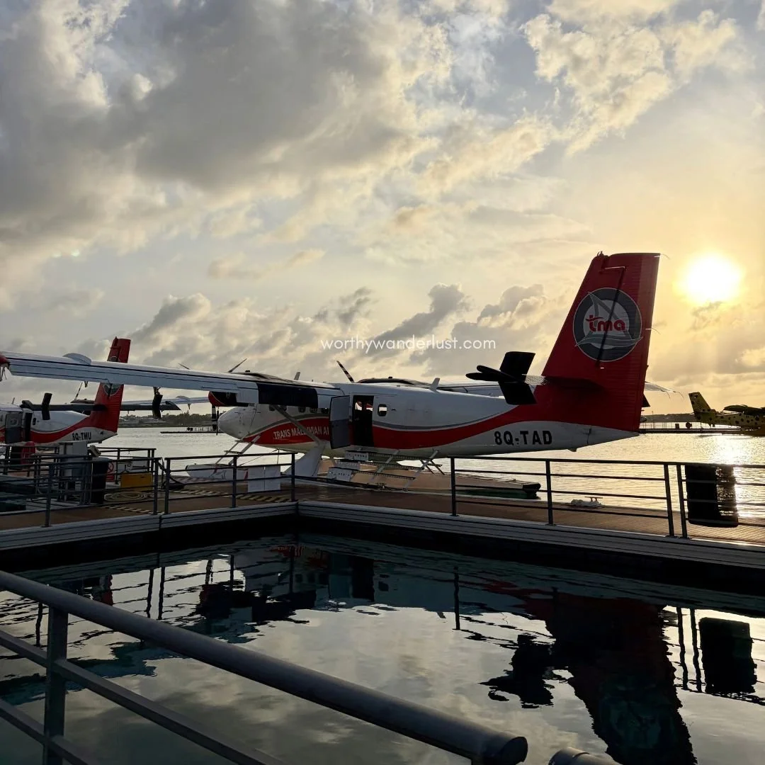 Seaplane at the seaplane terminal at Male Airport, with a sunrise backdrop.